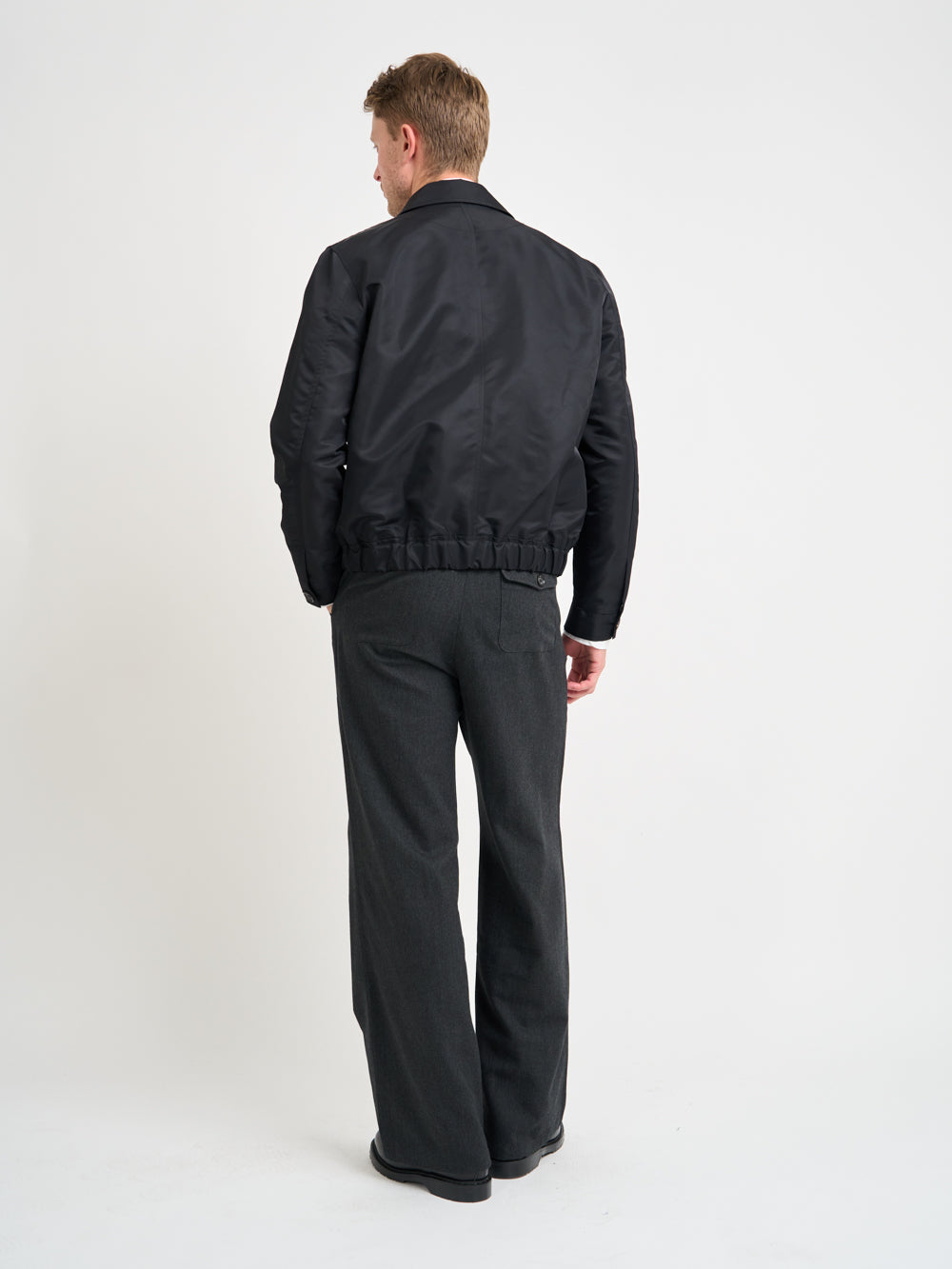 Back shot of model wearing Oliver Spencer Men's Water Repellent Black Bomber Jacket