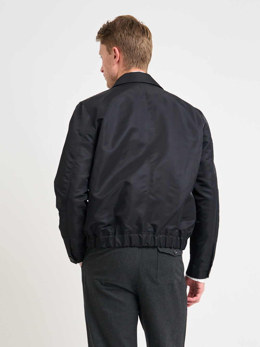 Close up back shot of model wearing Oliver Spencer Men&#39;s Water Repellent Black Bomber Jacket