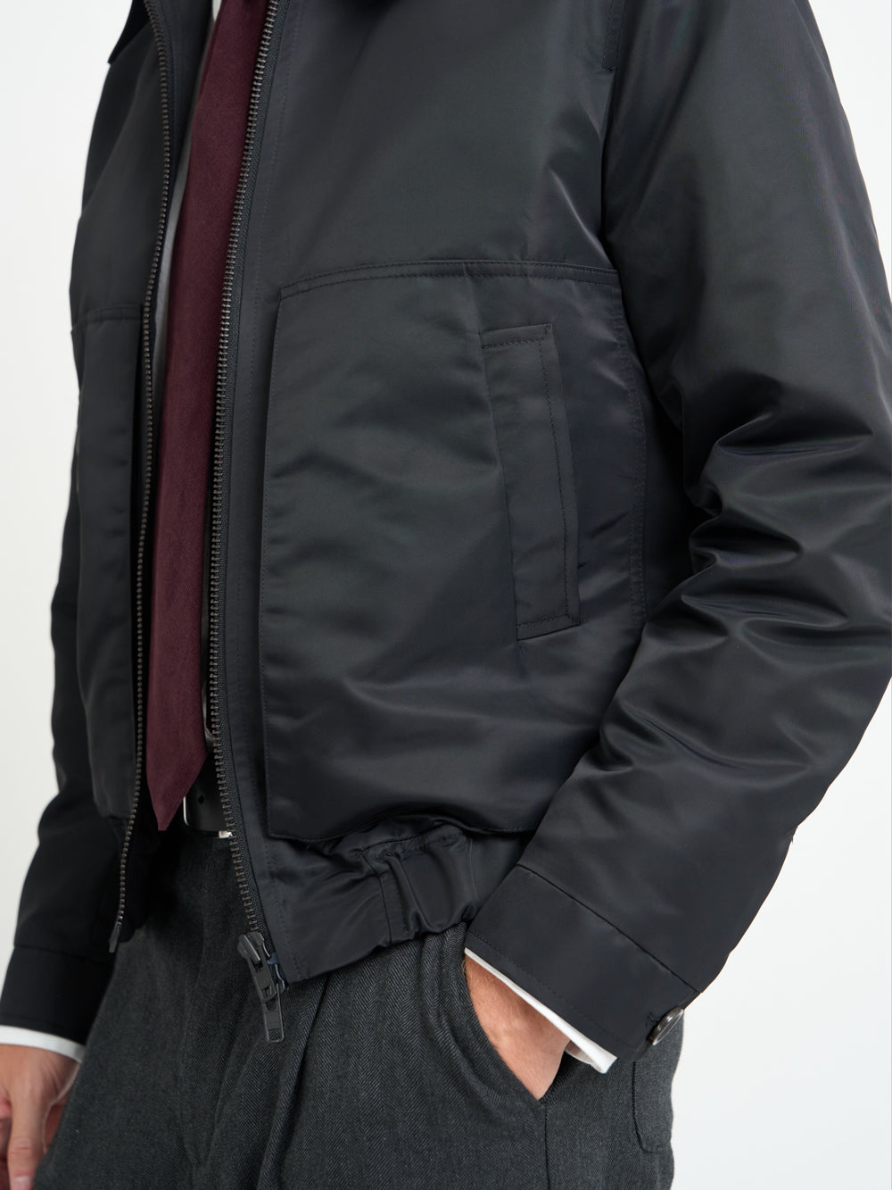 Close up side view shot of model wearing Oliver Spencer Men&#39;s Water Repellent Black Bomber Jacket