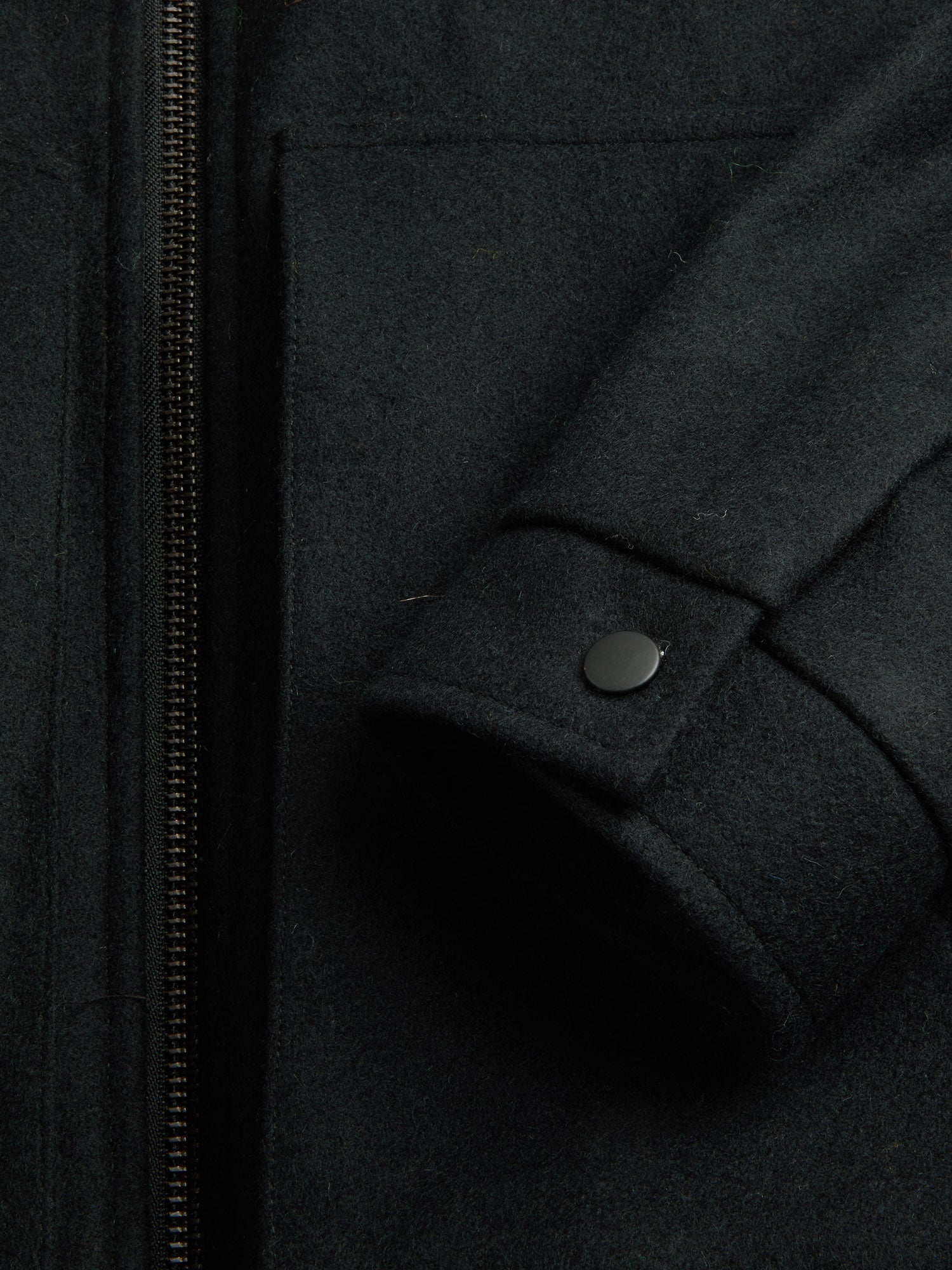 Detailed cuff shot of model wearing Oliver Spencer Men's Black Wool Bomber Jacket