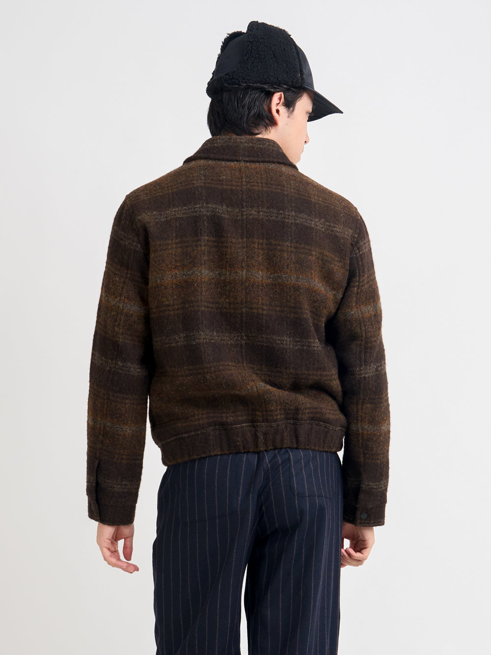 Close up back shot of model wearing Oliver Spencer Men's Brown Check Wool Bomber Jacket