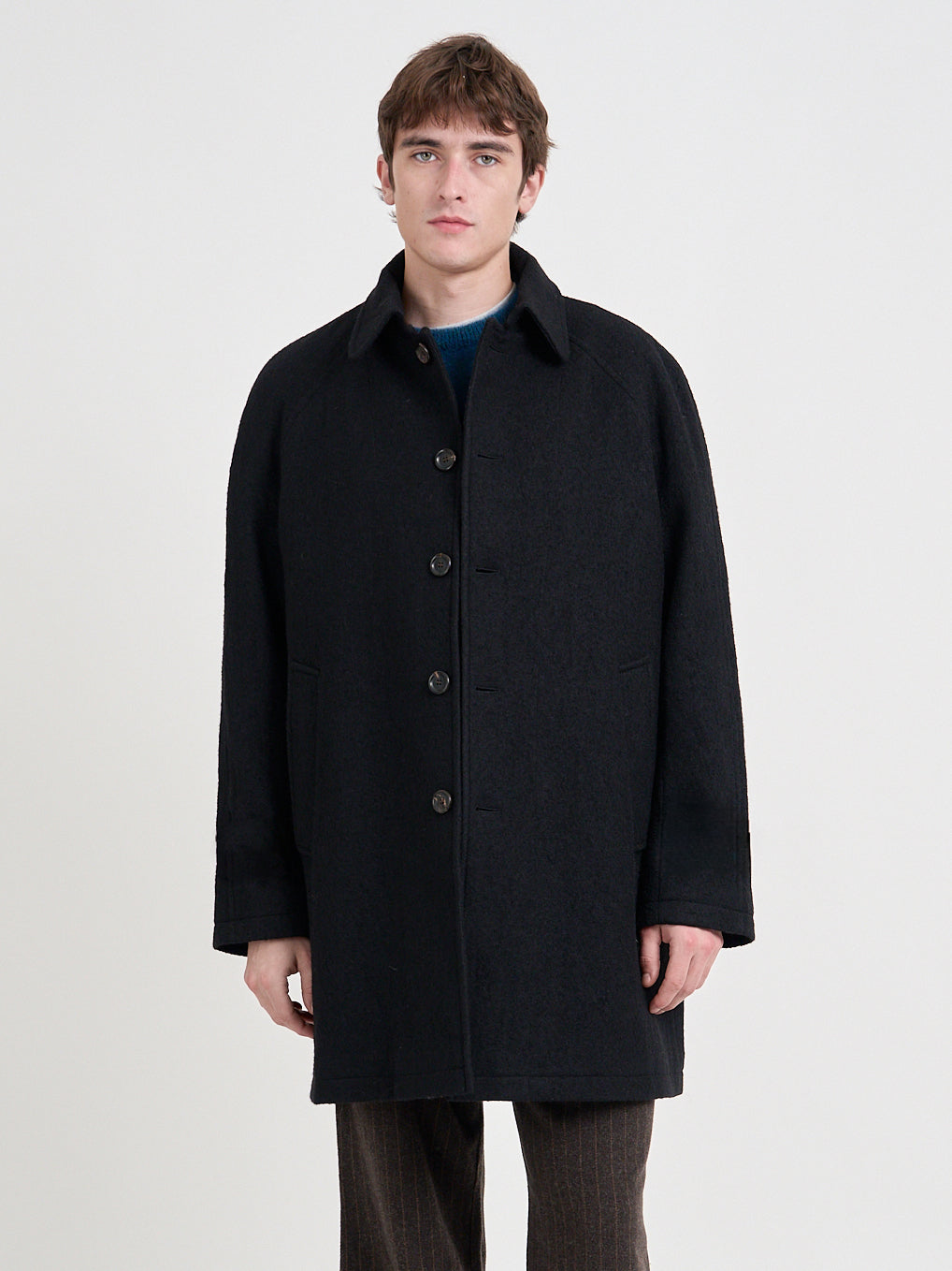 Close up shot of model wearing Oliver Spencer Men's Black Wool Car Coat