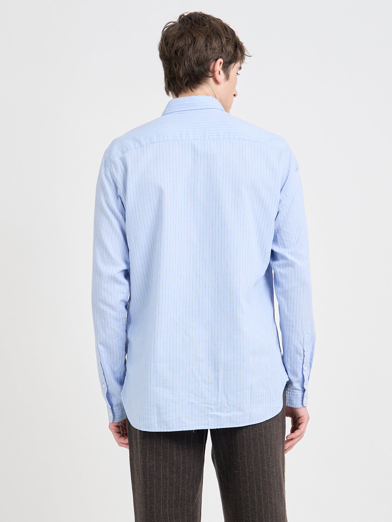 Back shot of model wearing Oliver Spencer Men&#39;s Pale Blue Pinstripe Organic Cotton Button-Down Shirt