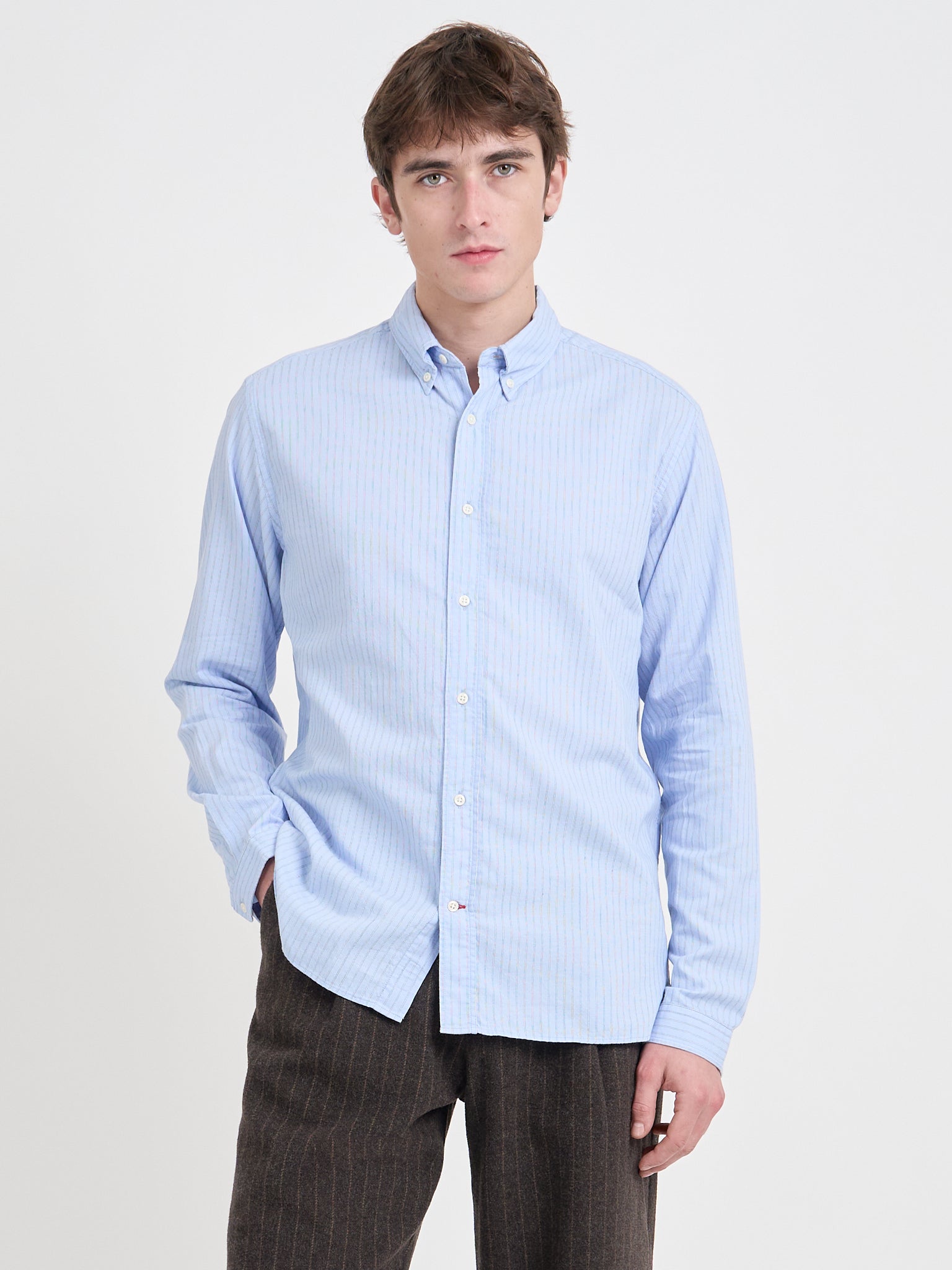 Close up shot of model wearing Oliver Spencer Men&#39;s Pale Blue Pinstripe Organic Cotton Button-Down Shirt