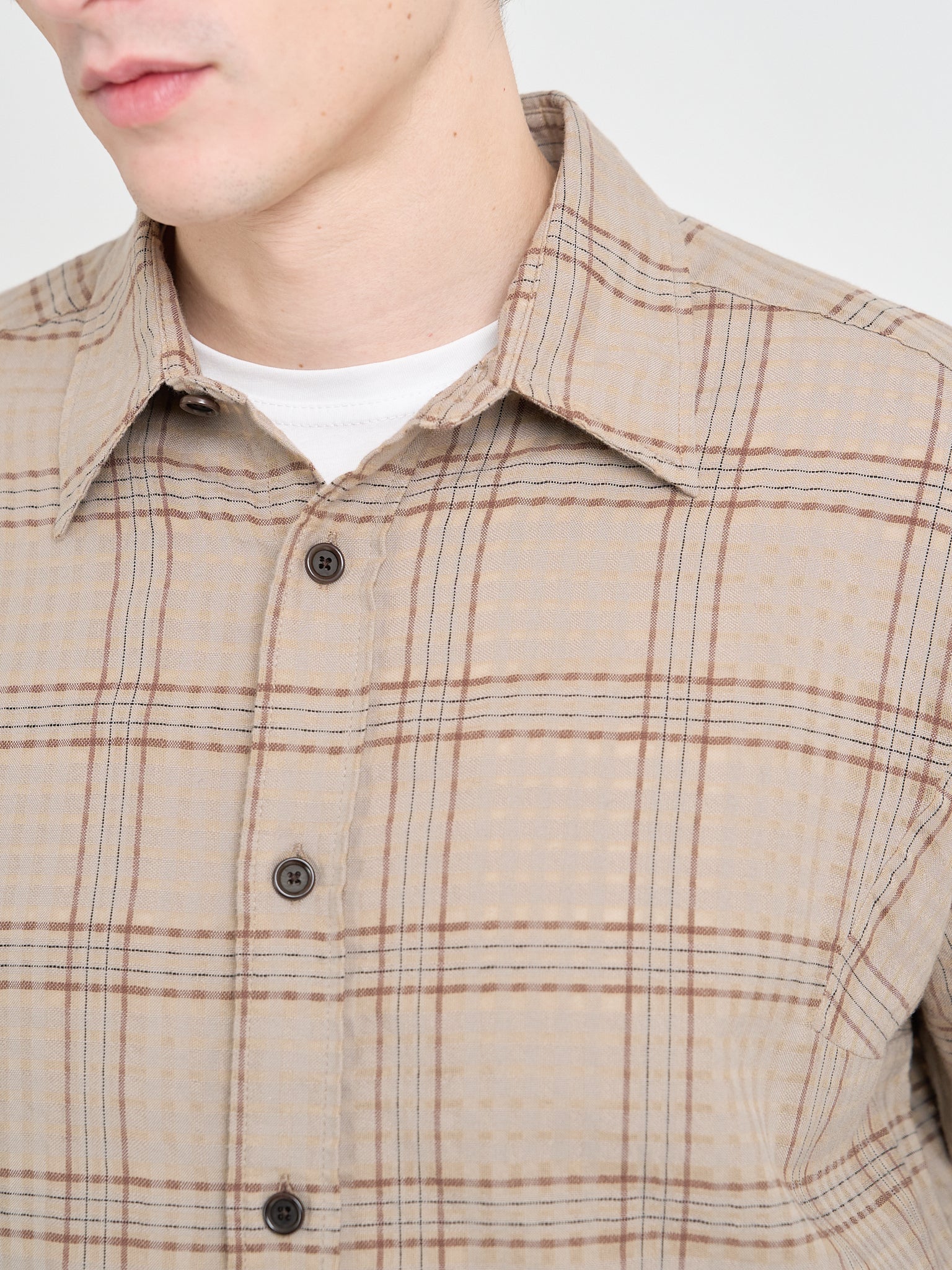 Detailed close up of Model wearing a Loose Fitting Oliver Spencer Garrison Long Sleeve Shirt in Connell Beige