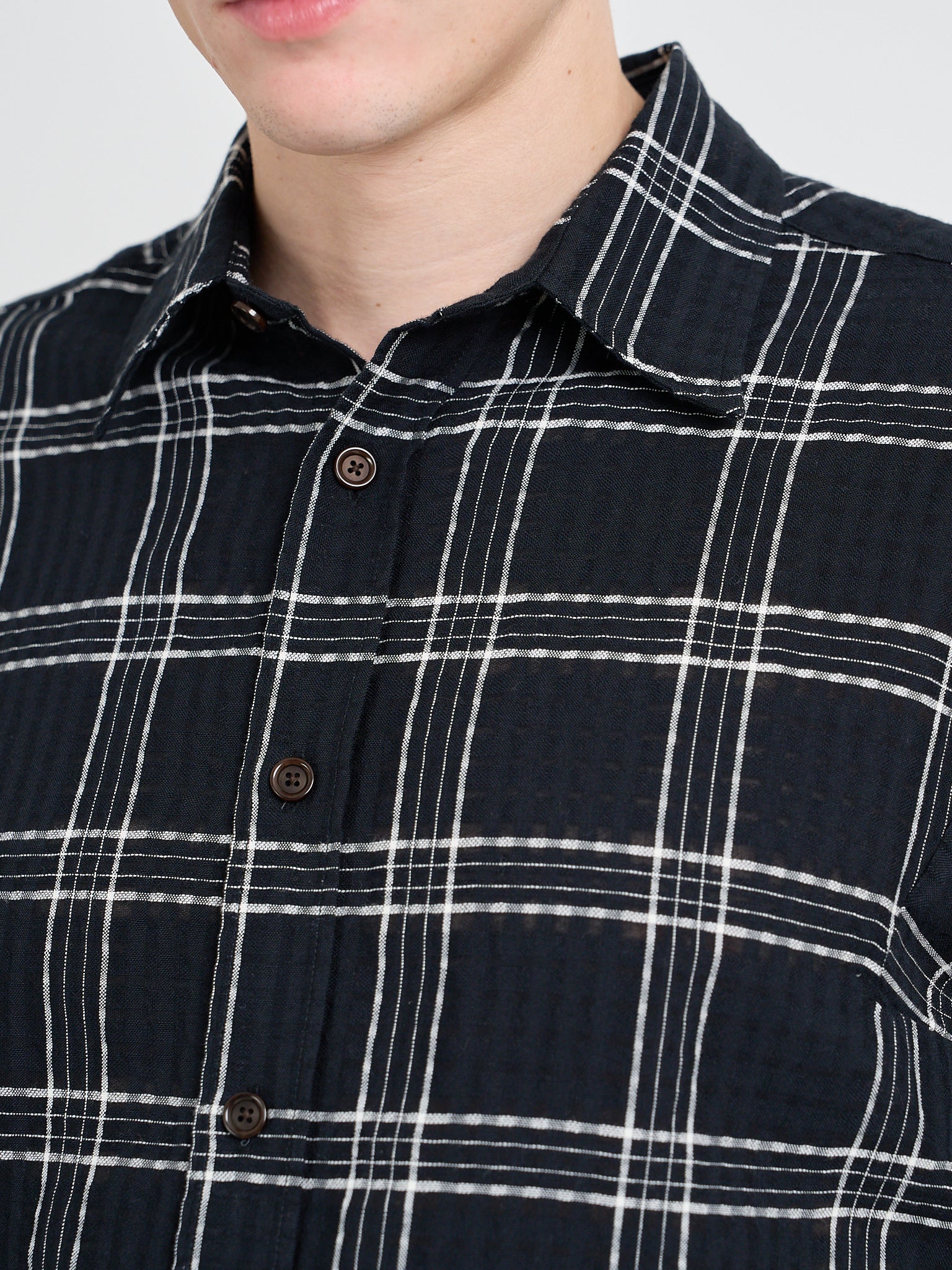 Close up shot of model wearing Oliver Spencer Loose Fitting Garrison Long Sleeve Shirt in Connell Black