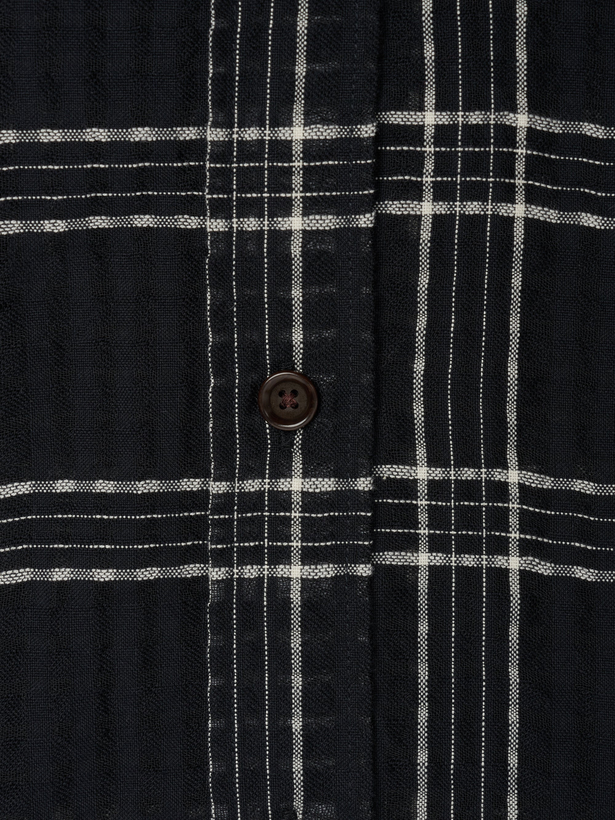 Detailed button shot of Oliver Spencer Men&#39;s Black Organic Cotton Check Overshirt