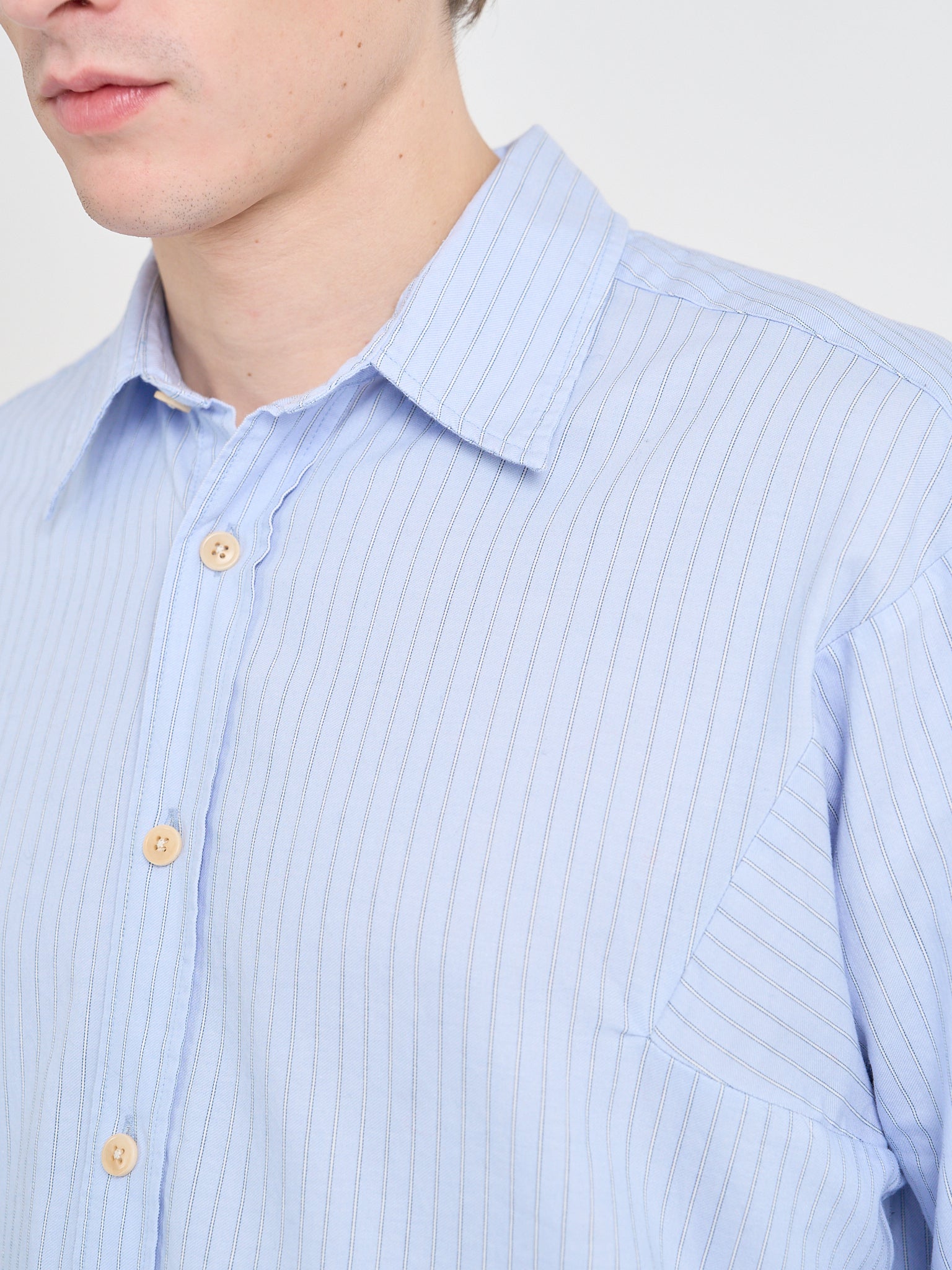 Close up shot of model wearing Oliver Spencer Loose Fitting Garrison Long Sleeve Shirt in Faber Blue