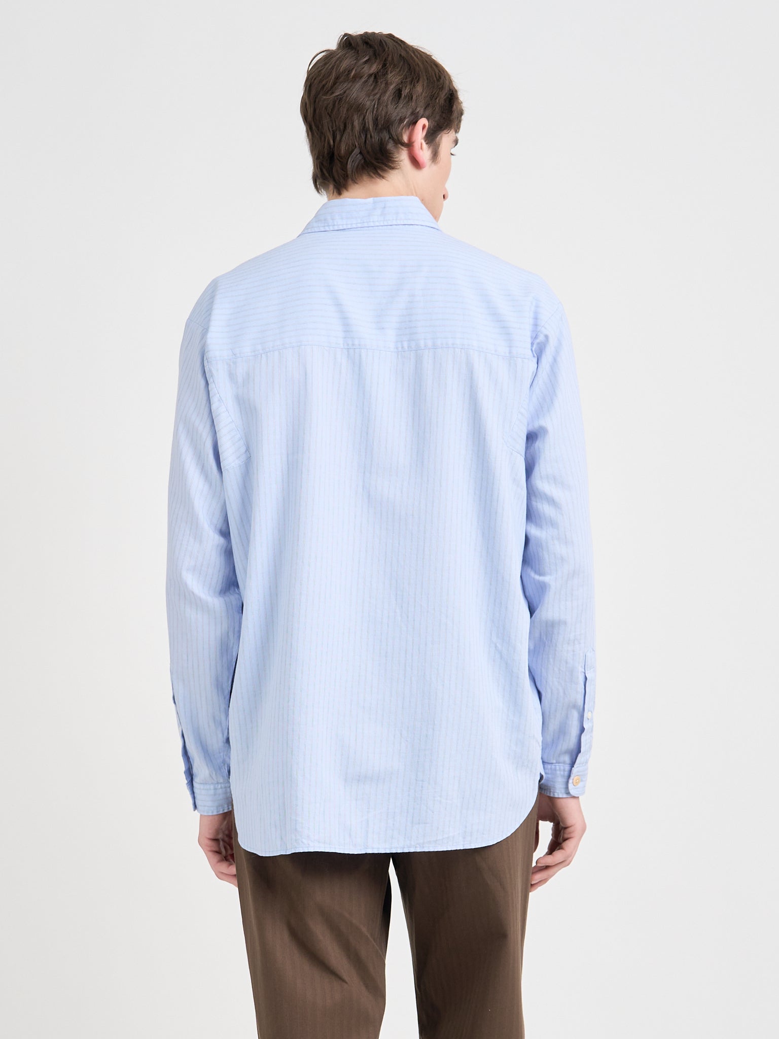 Back shot of model wearing Oliver Spencer Loose Fitting Garrison Long Sleeve Shirt in Faber Blue