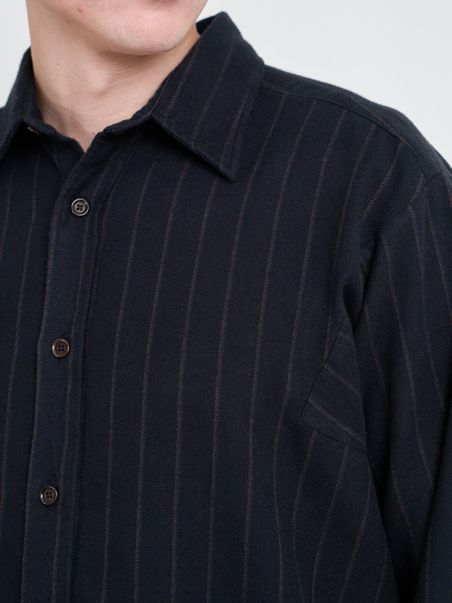 Detailed collar shot of Model wearing an Oliver Spencer Loose Fitting Garrison Long Sleeve Shirt in Nielson Navy