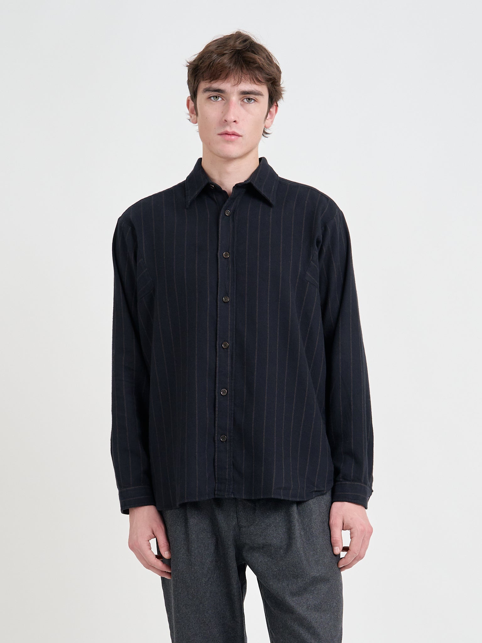 Model wearing an Oliver Spencer Loose Fitting Garrison Long Sleeve Shirt in Nielson Navy