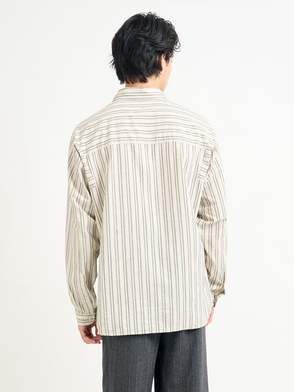 Closer up back shot of model wearing Oliver Spencer Men&#39;s Oversized Striped Cream Spread Collar Cotton Shirt