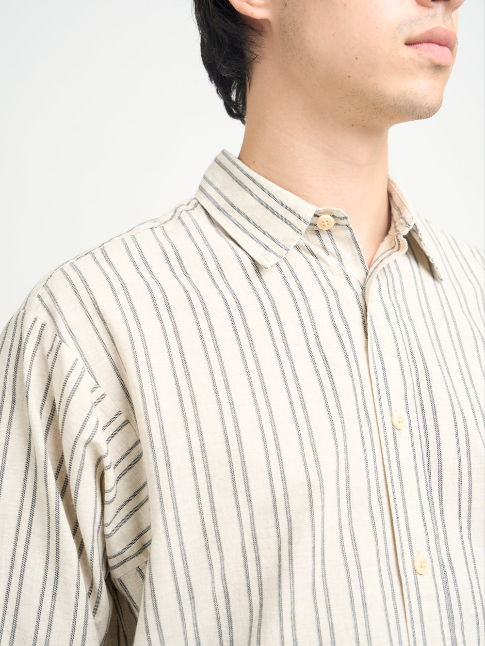 Detailed collar shot of model wearing Oliver Spencer Men&#39;s Oversized Striped Cream Spread Collar Cotton Shirt