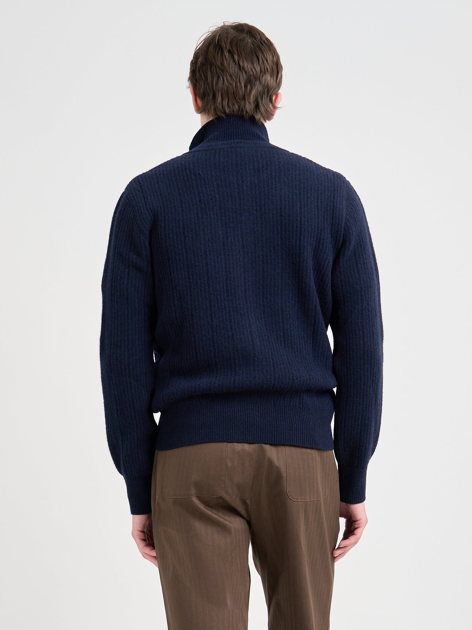 Close up back shot of model wearing Oliver Spencer Men's Navy Zip up Wool Cardigan