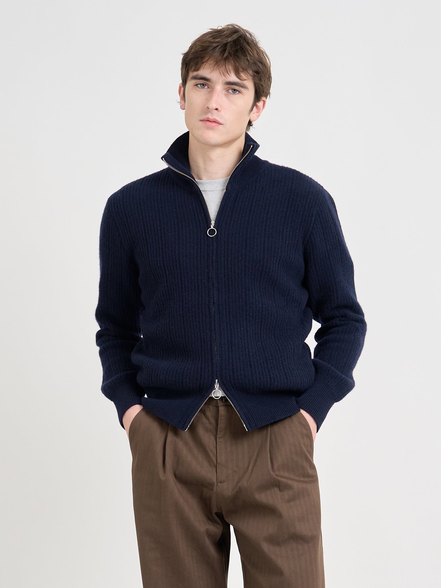 Detailed close shot of model wearing Oliver Spencer Men's Navy Zip up Wool Cardigan