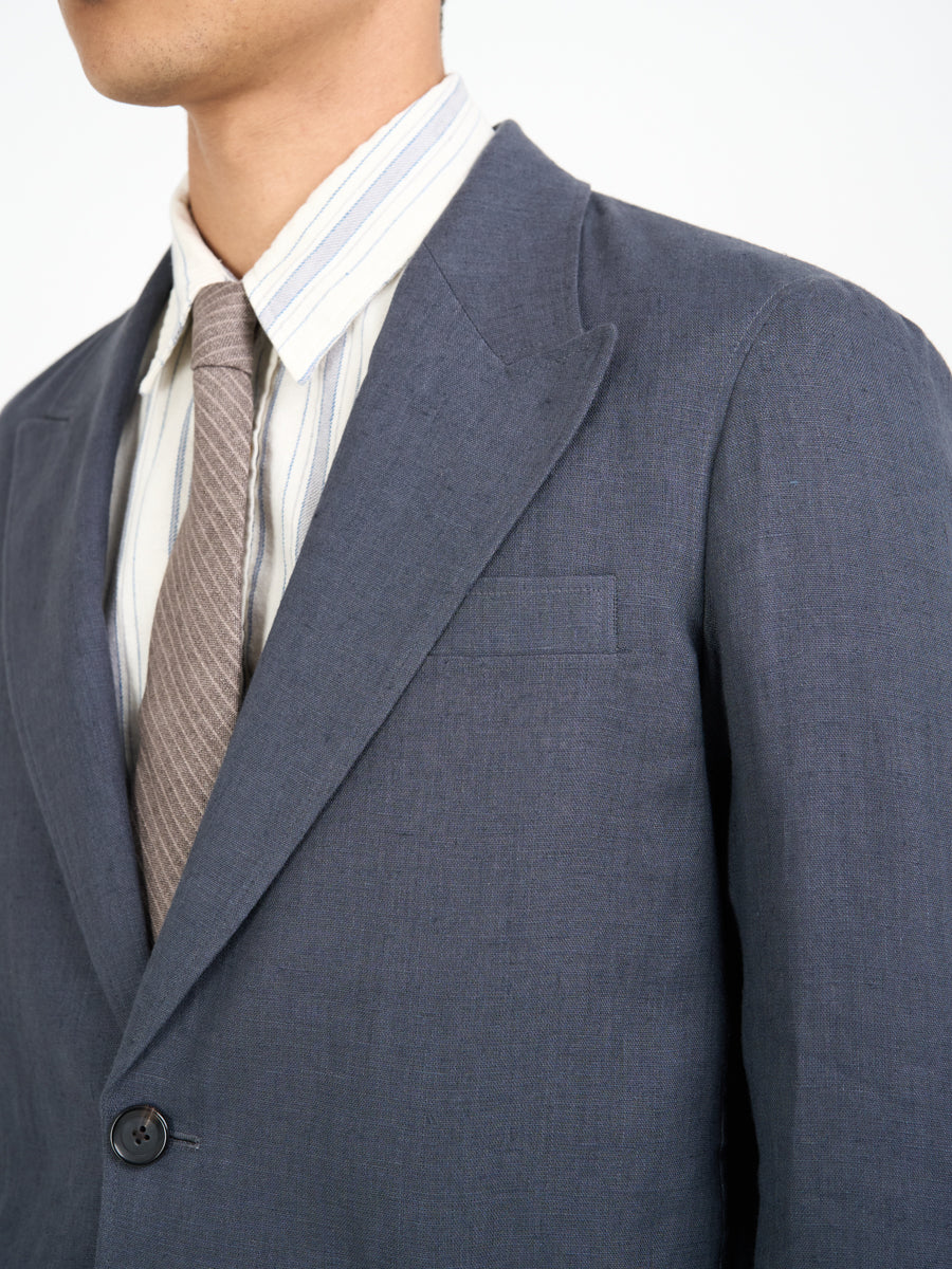 Detailed collar shot of model wearing Oliver Spencer Men's Single Breasted Peak Lapel Linen Jacket