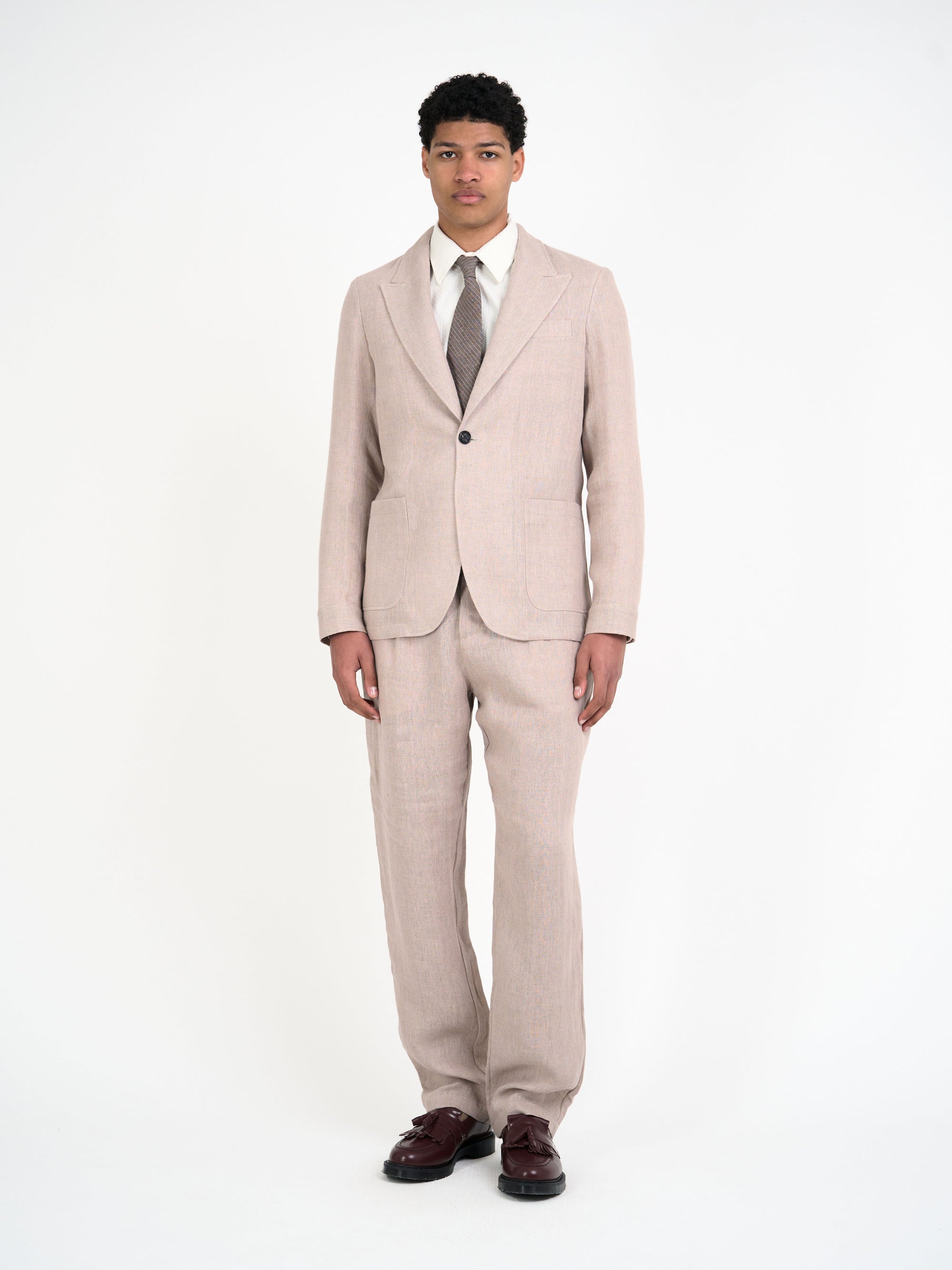Model wearing Oliver Spencer Men's Single Breasted Peak Lapel Pink Linen Jacket