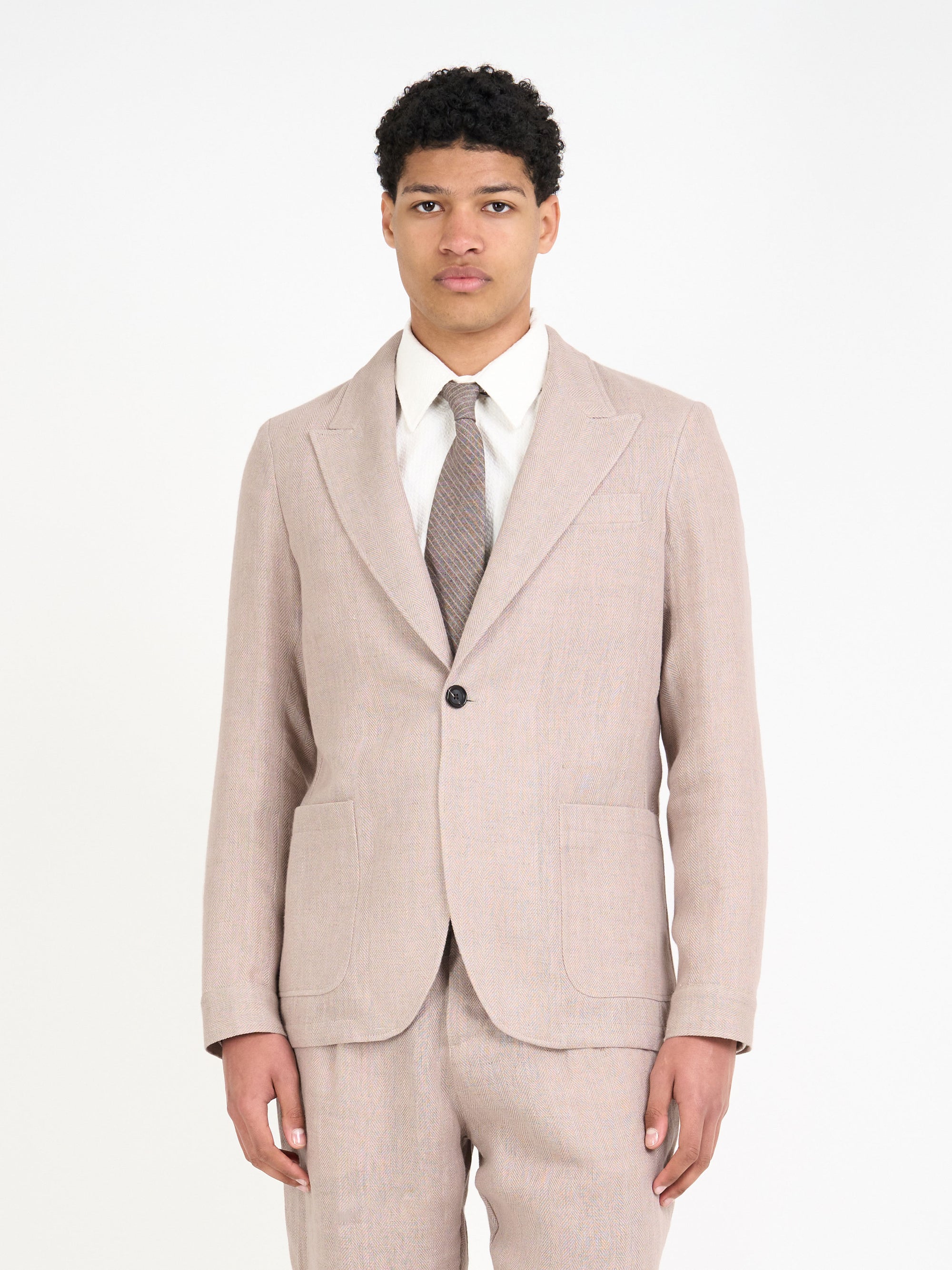 Detailed close up shot of model wearing Oliver Spencer Men's Single Breasted Peak Lapel Pink Linen Jacket