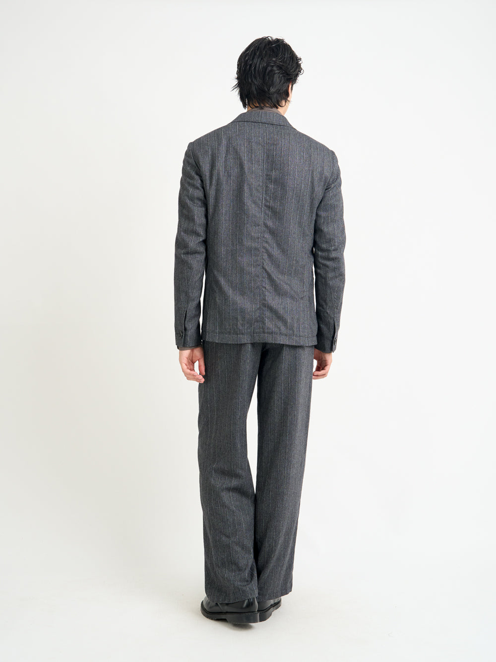 Back shot of model wearing Oliver Spencer Men's Unstructured Peak Lapel Grey Striped Jacket