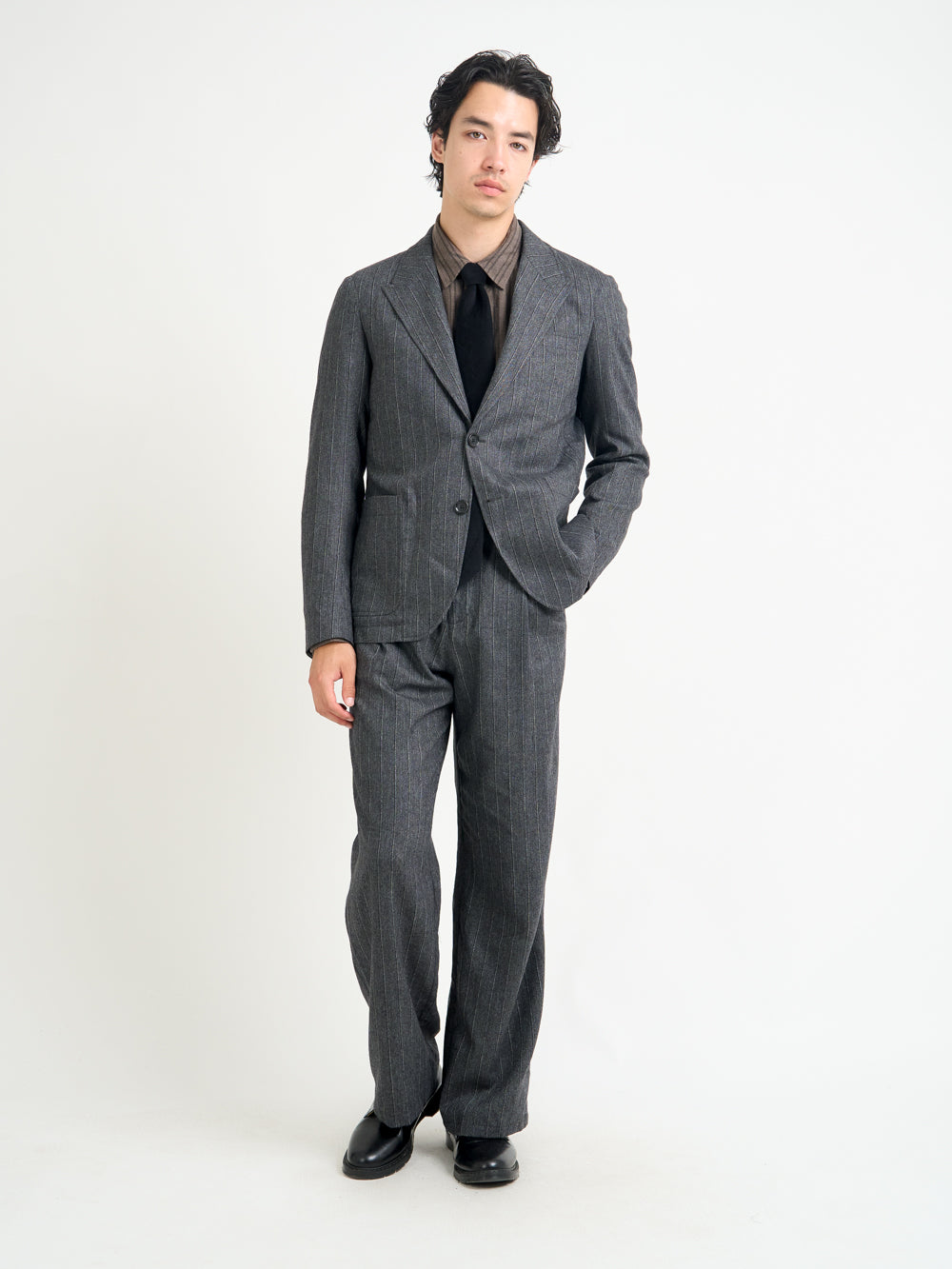 Model wearing Oliver Spencer Men's Unstructured Peak Lapel Grey Striped Jacket