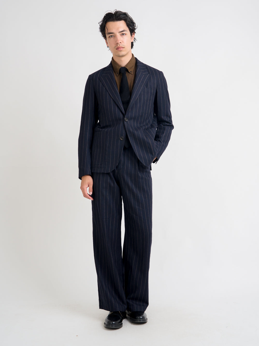 Model wearing Oliver Spencer Men's Unstructured Peak Lapel Navy Striped Jacket