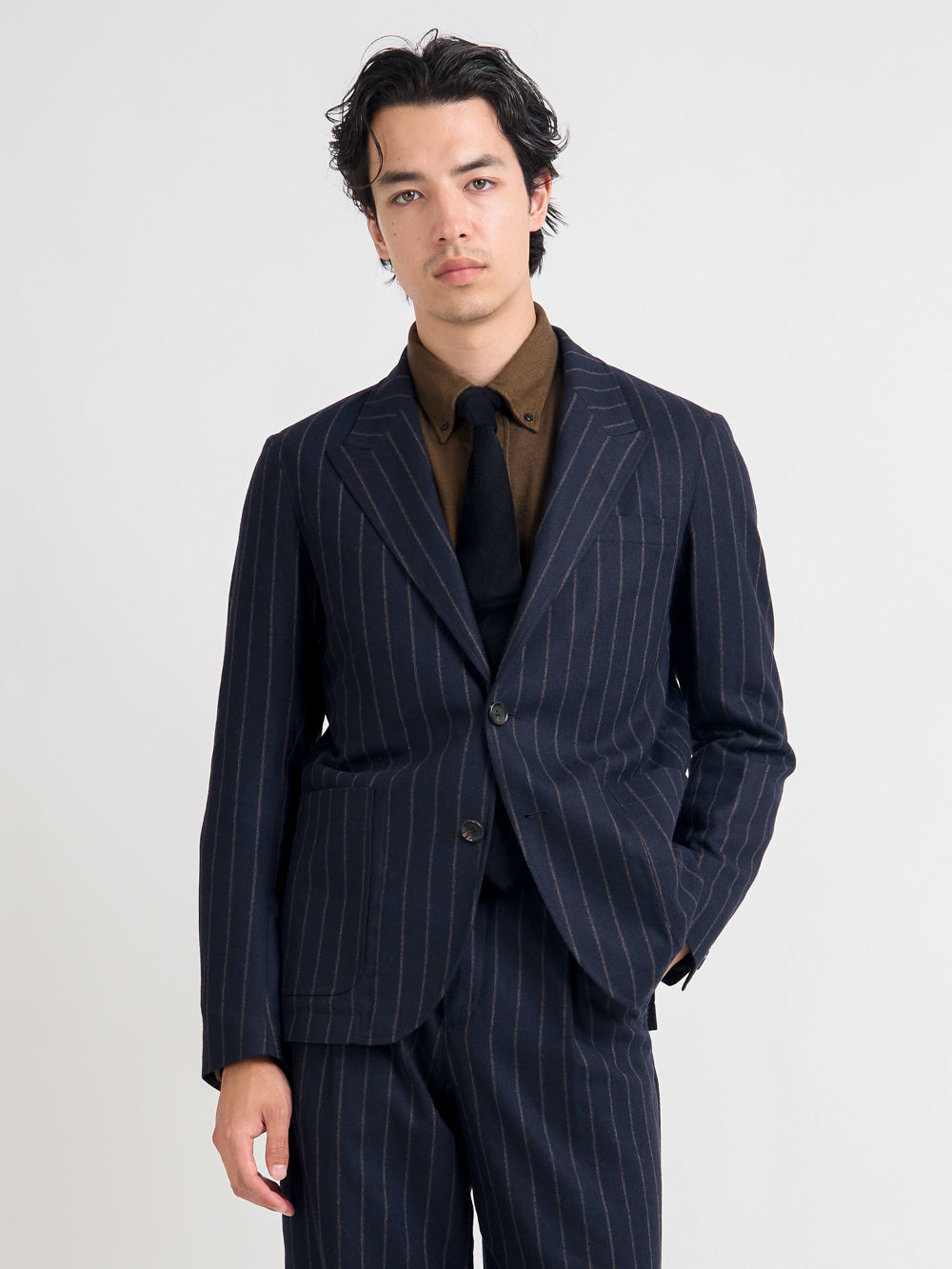 Close up shot of model wearing Oliver Spencer Men's Unstructured Peak Lapel Navy Striped Jacket