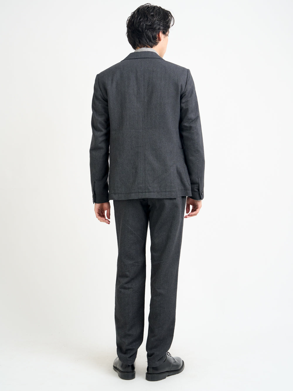 Back shot of model wearing Oliver Spencer Men's Unstructured Peak Lapel Grey Jacket