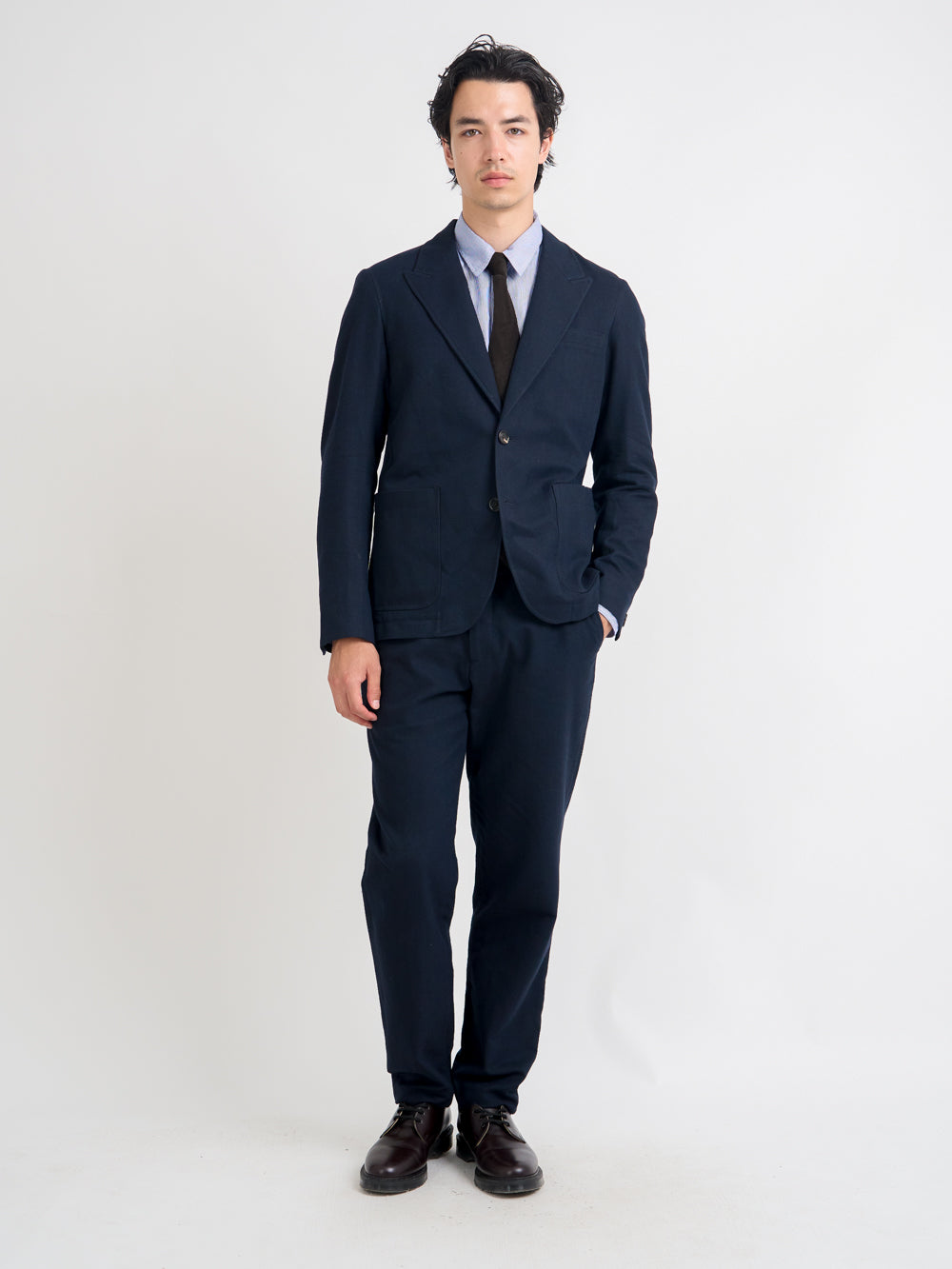 Model wearing Oliver Spencer Men's Unstructured Peak Lapel Navy Cotton Jacket
