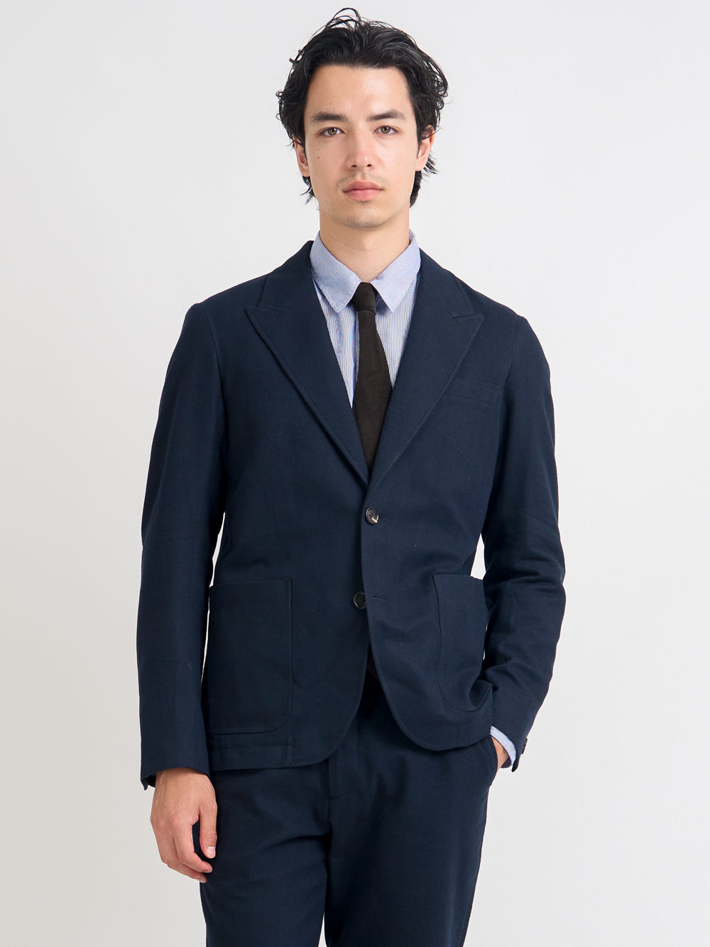 Closer up shot of model wearing Oliver Spencer Men's Unstructured Peak Lapel Navy Cotton Jacket