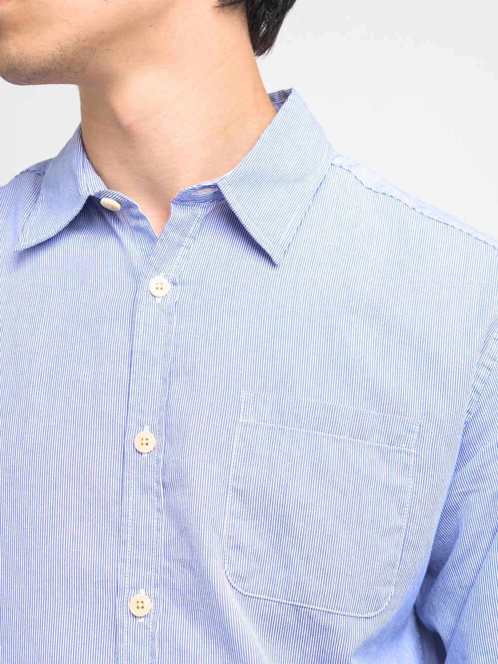 Close up collar shot of model wearing Oliver Spencer Striped Light Blue and White Spear Collar Organic Cotton Shirt