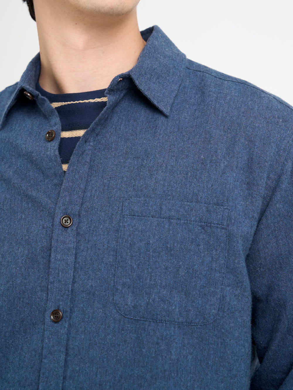 Close up collar shot of model wearing Oliver Spencer Navy Spear Collar Cotton Shirt