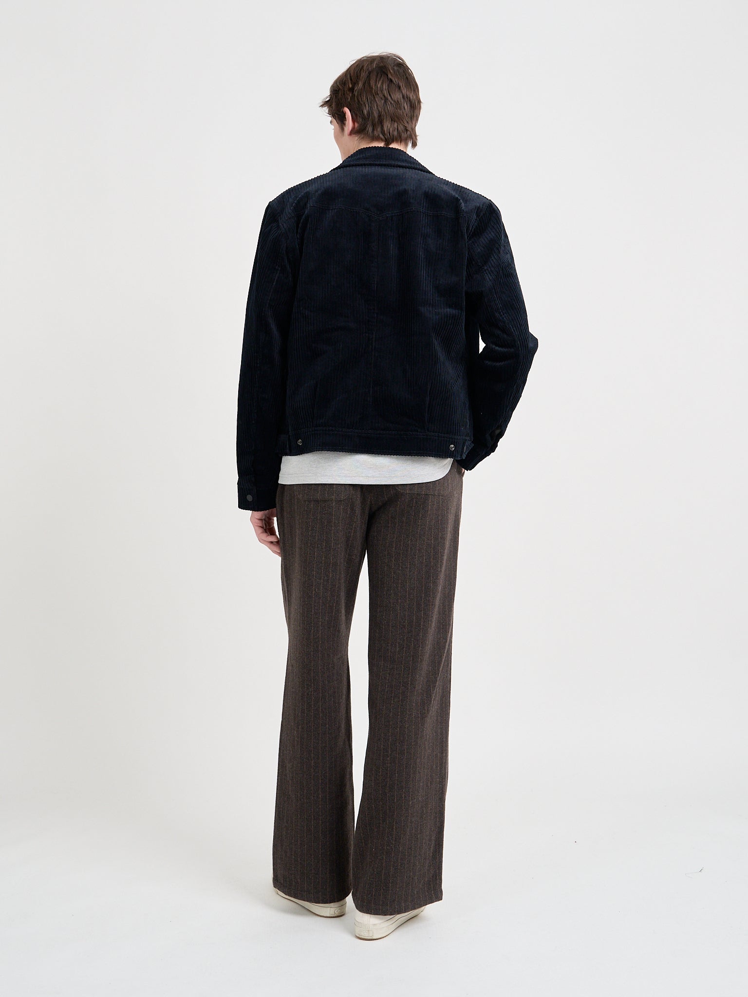 Back shot of model wearing Oliver Spencer Men's Midnight Navy Cotton Corduroy Trucker Jacket Flat Shot