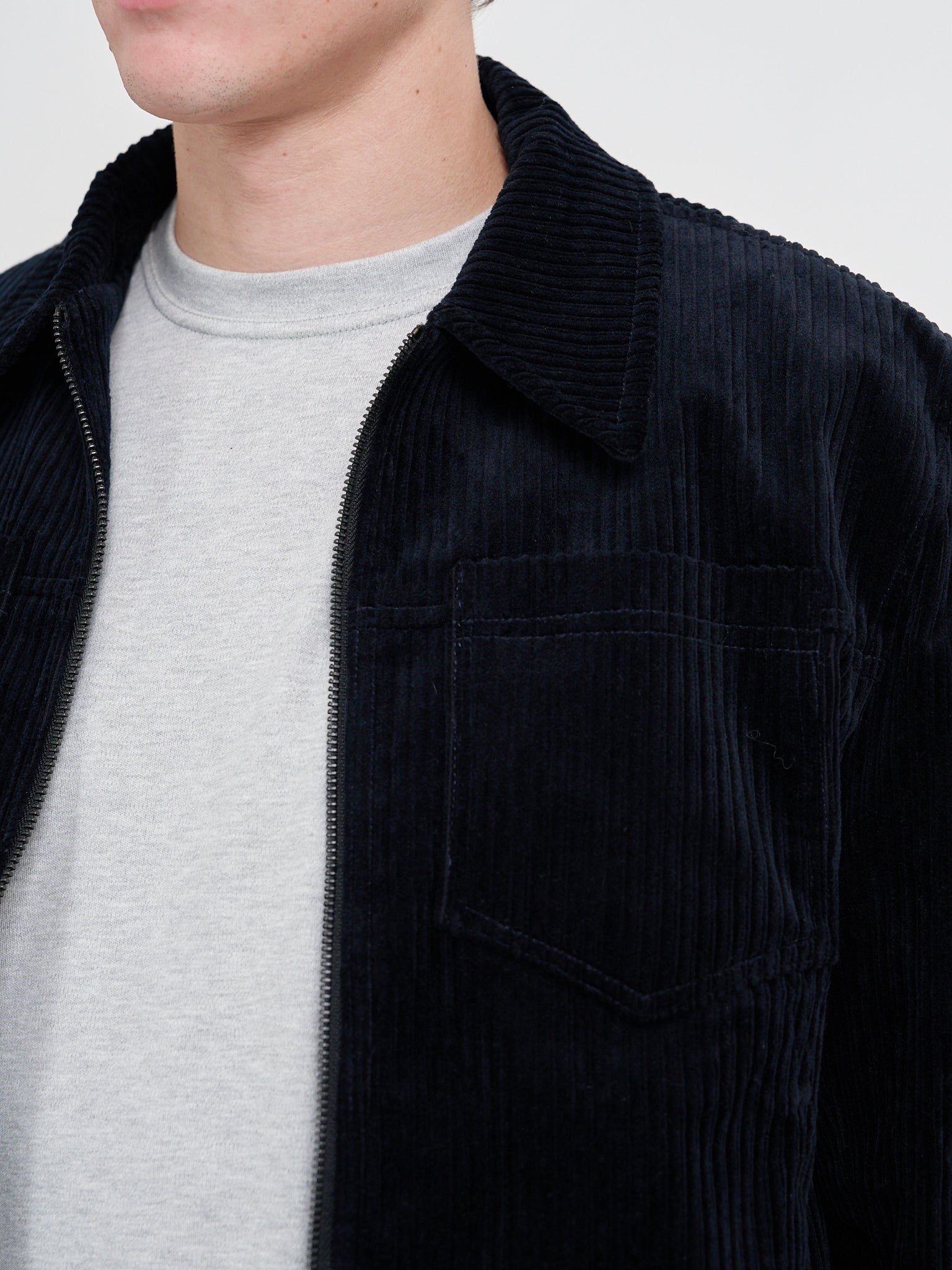 Close up collar shot of model wearing Oliver Spencer Men's Midnight Navy Cotton Corduroy Trucker Jacket Flat Shot