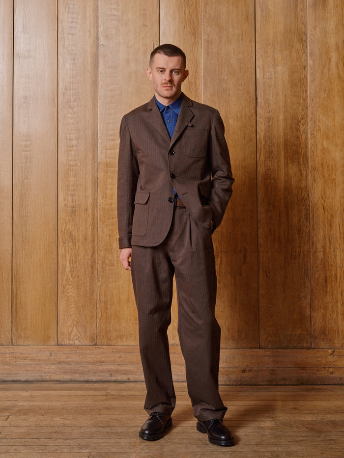 Grey pinstripe wool suit jacket worn with a pink shirt and brown wool tie