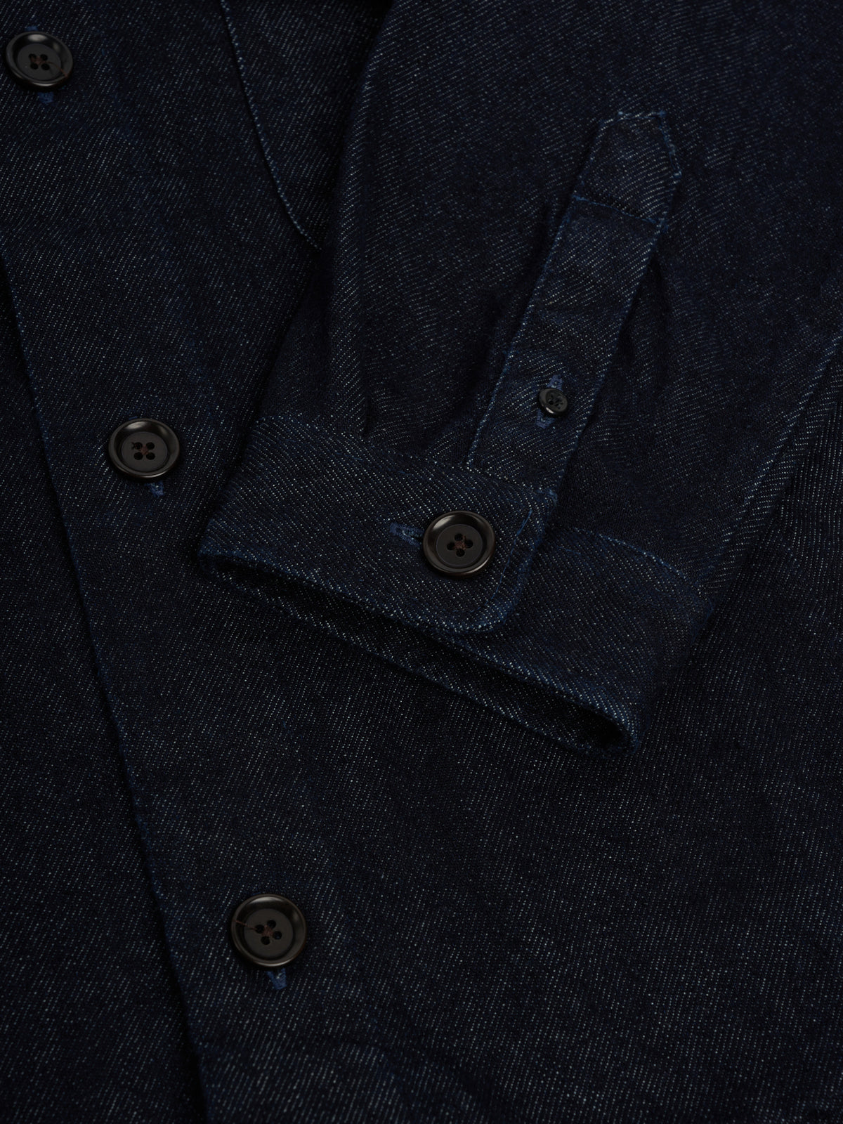 Cuff. A sleeve cuff with a sleeve tab and button, beside the front buttons.