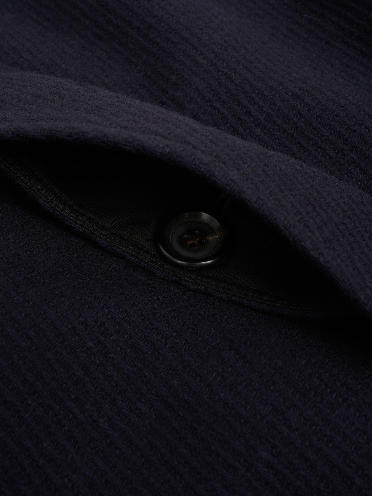 Fly front. The buttons sit behind a concealed placket.