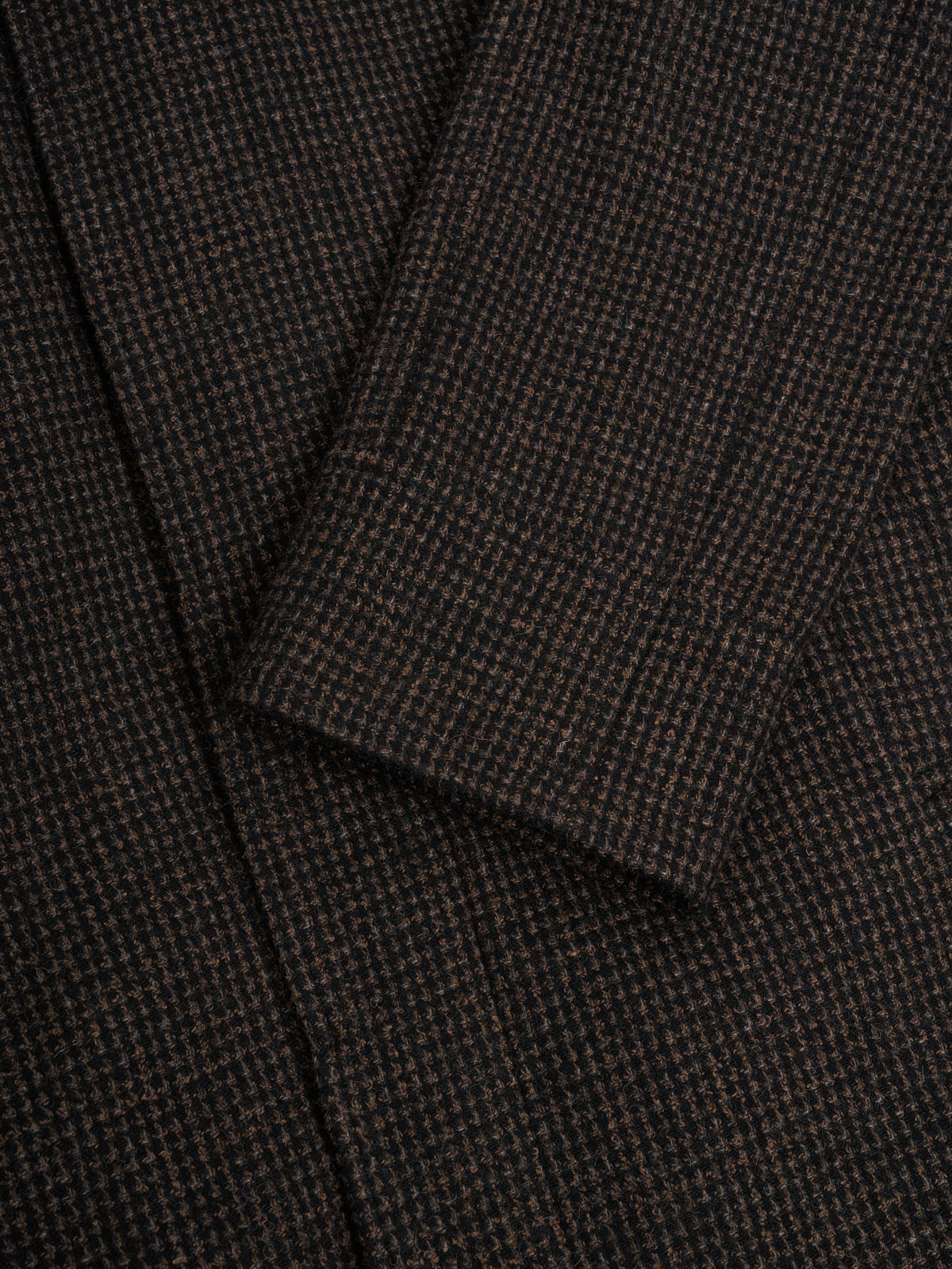 Cuff. No button, so the sleeve finishes in one clean line.