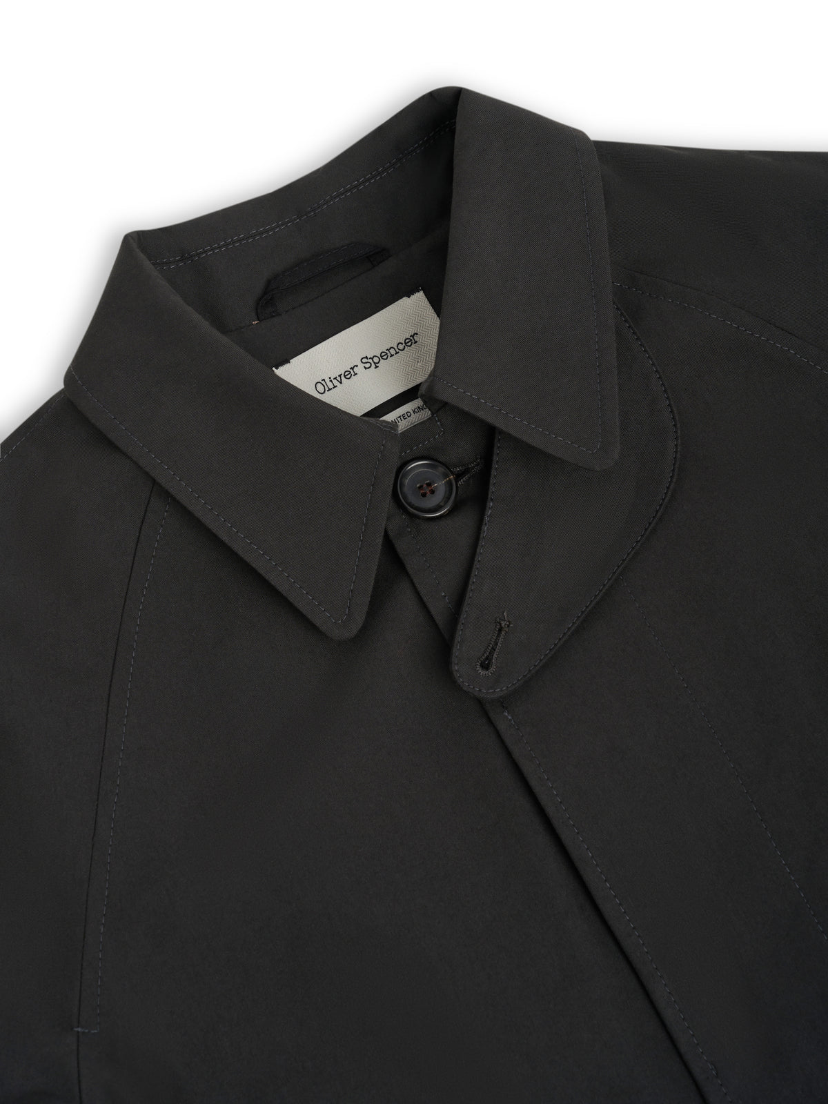 Collar. A storm guard at the collar end, with one button exposed at the neck.