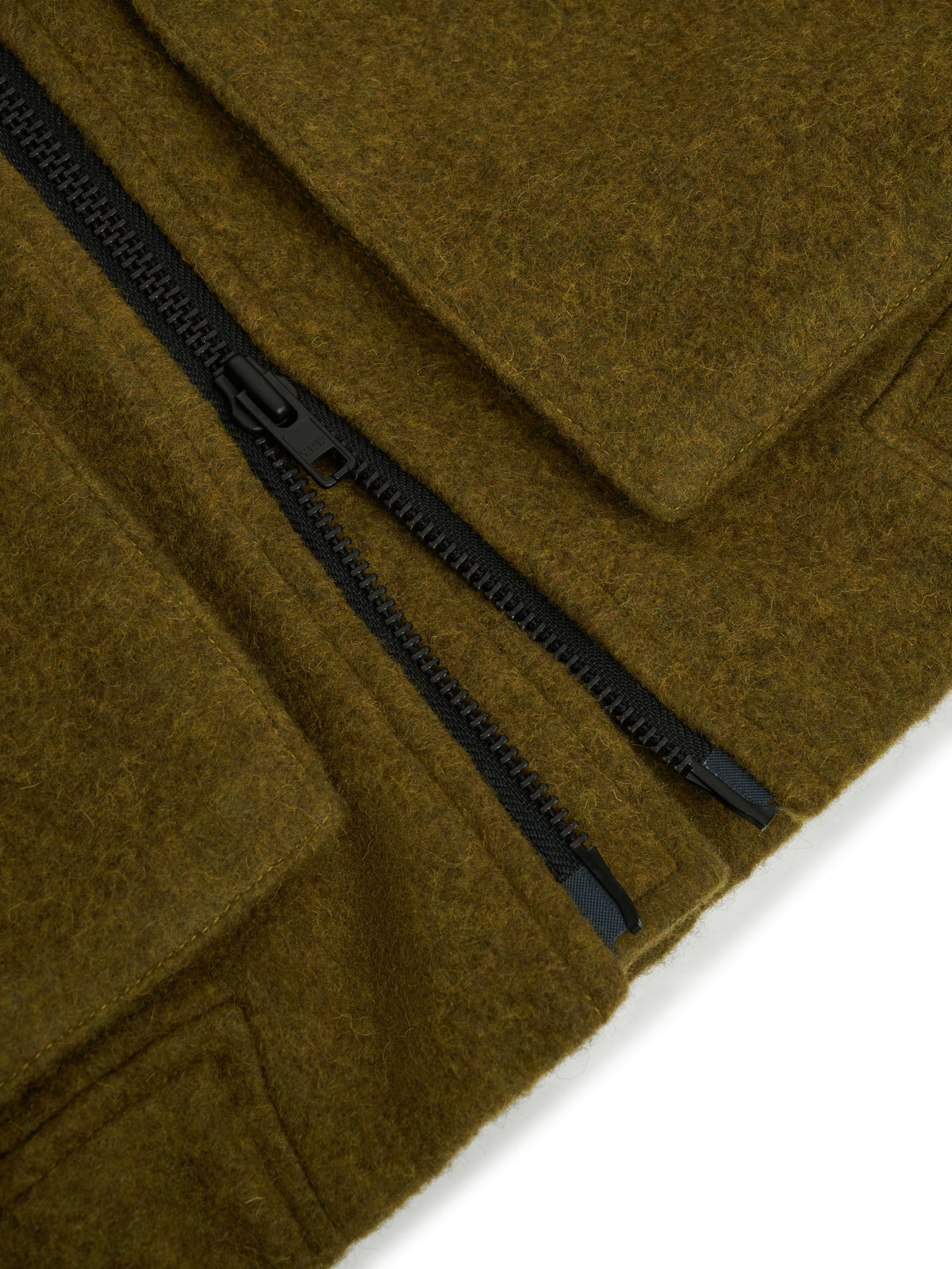 Zip. An open-ended zip with a black pull at the hem.