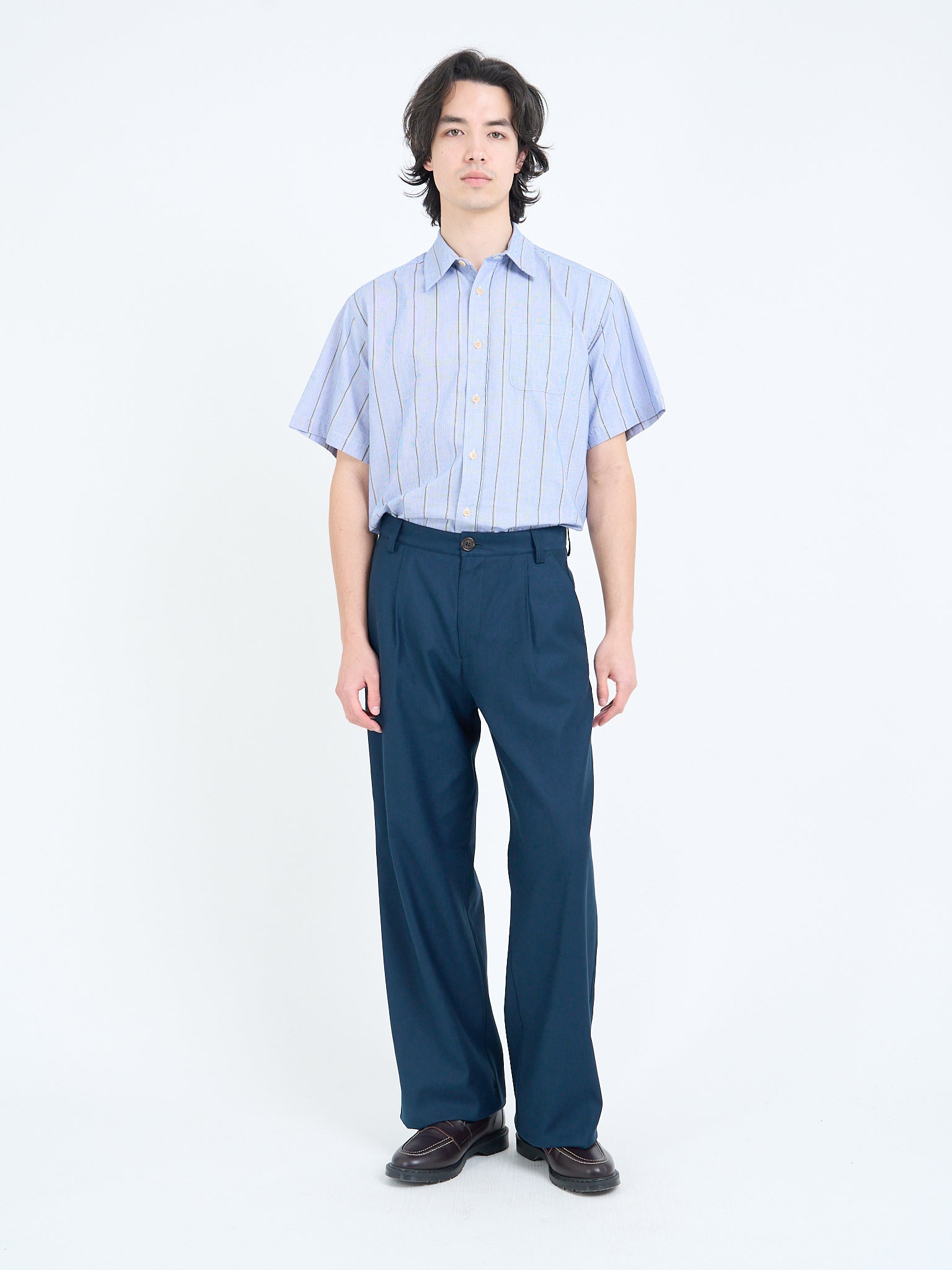 Wide-leg navy trousers styled with short-sleeve shirt, full length