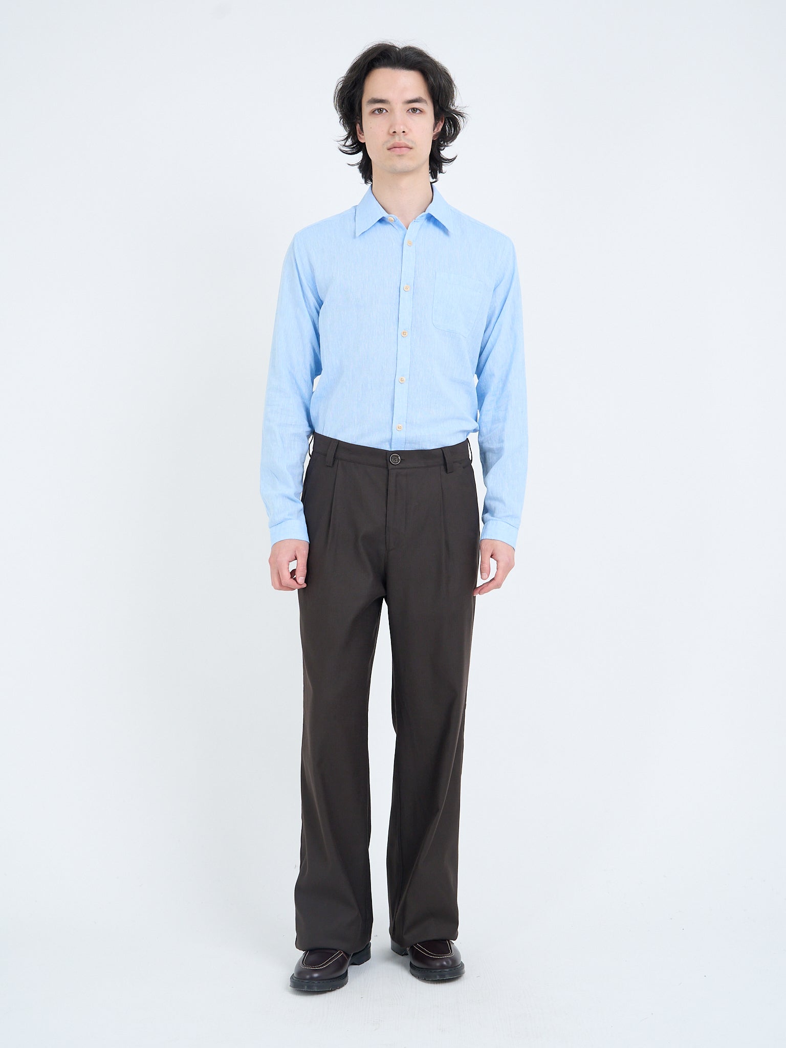 Oliver Spencer Eastman brown pleated trousers worn with light blue shirt