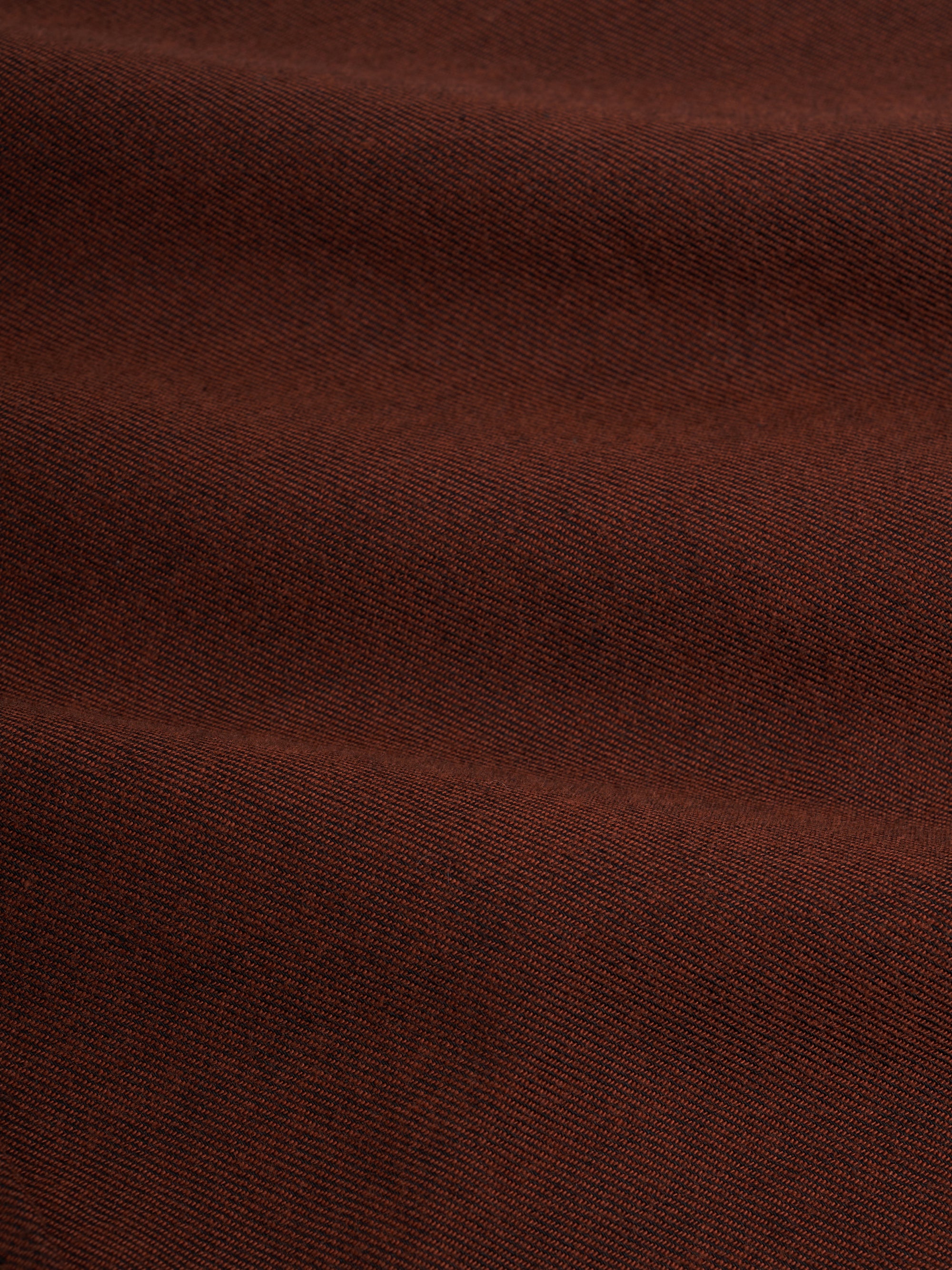 Close up material shot of model wearing an Oliver Spencer Penryn Overshirt in Banfield Rust