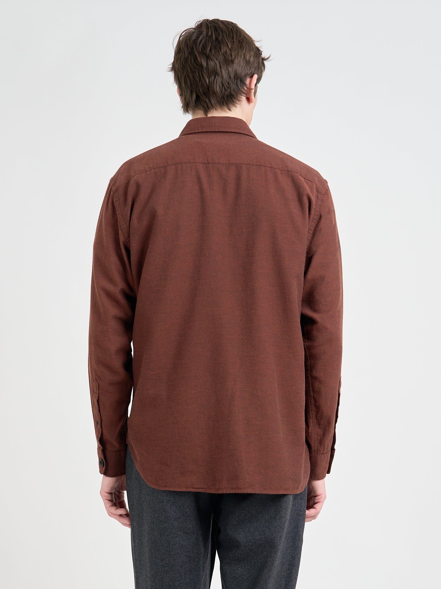 Close up back shot of model wearing an Oliver Spencer Penryn Overshirt in Banfield Rust