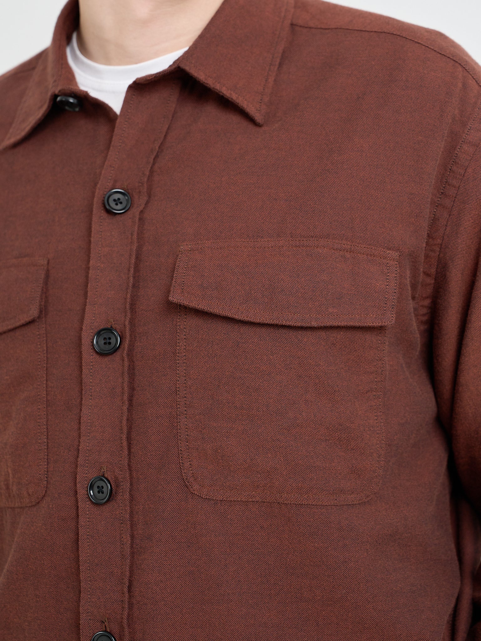 Close up collar shot of model wearing an Oliver Spencer Penryn Overshirt in Banfield Rust