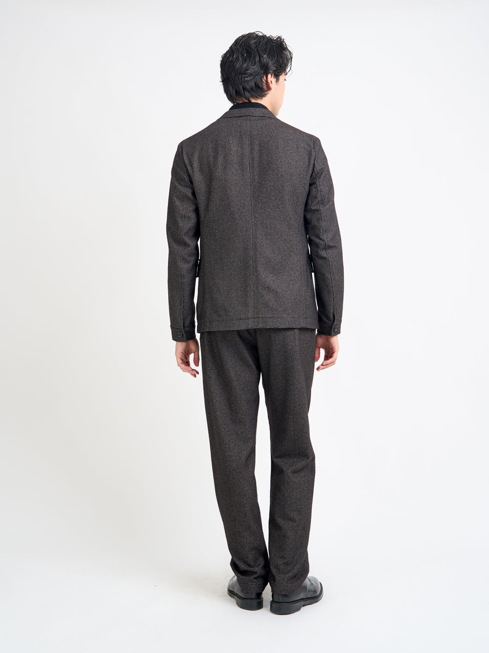 Back shot of model wearing Oliver Spencer Men's Unstructured Notch Lapel Brown Jacket