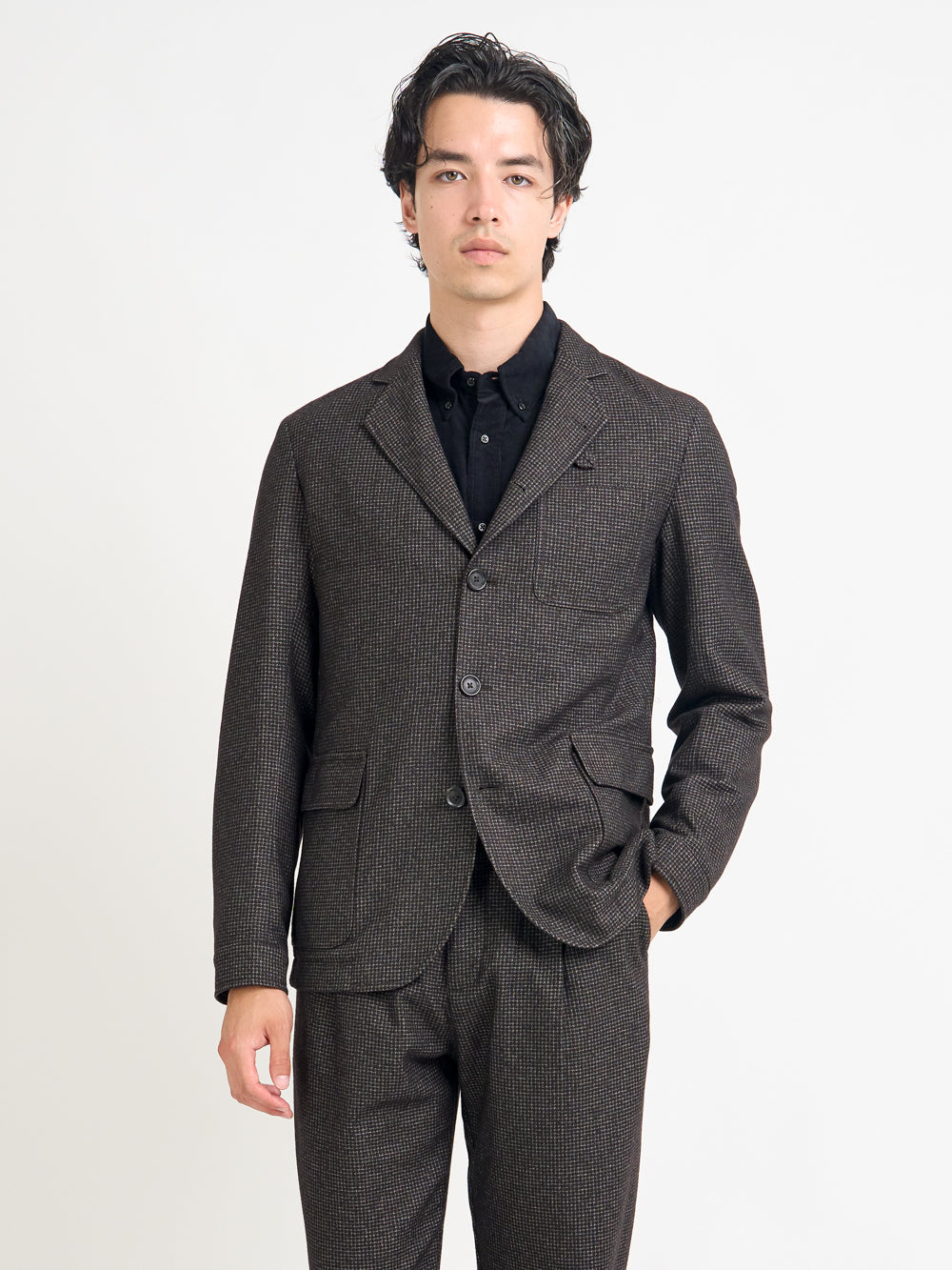 Close up shot of model wearing Oliver Spencer Men's Unstructured Notch Lapel Brown Jacket