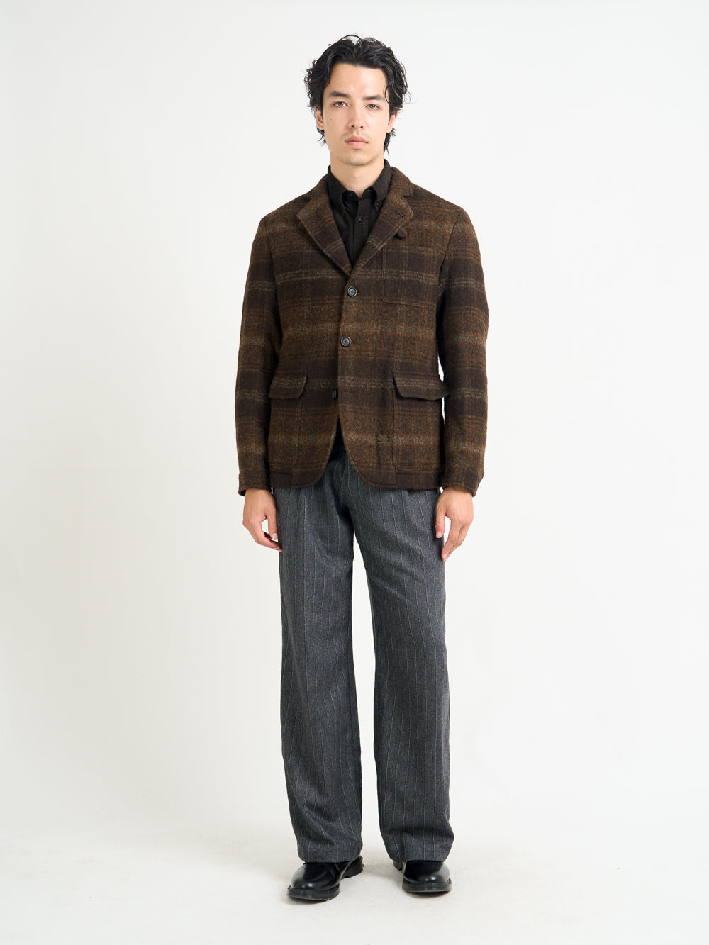 Model wearing Oliver Spencer Men's Unstructured Notch Lapel Brown Plaid Jacket