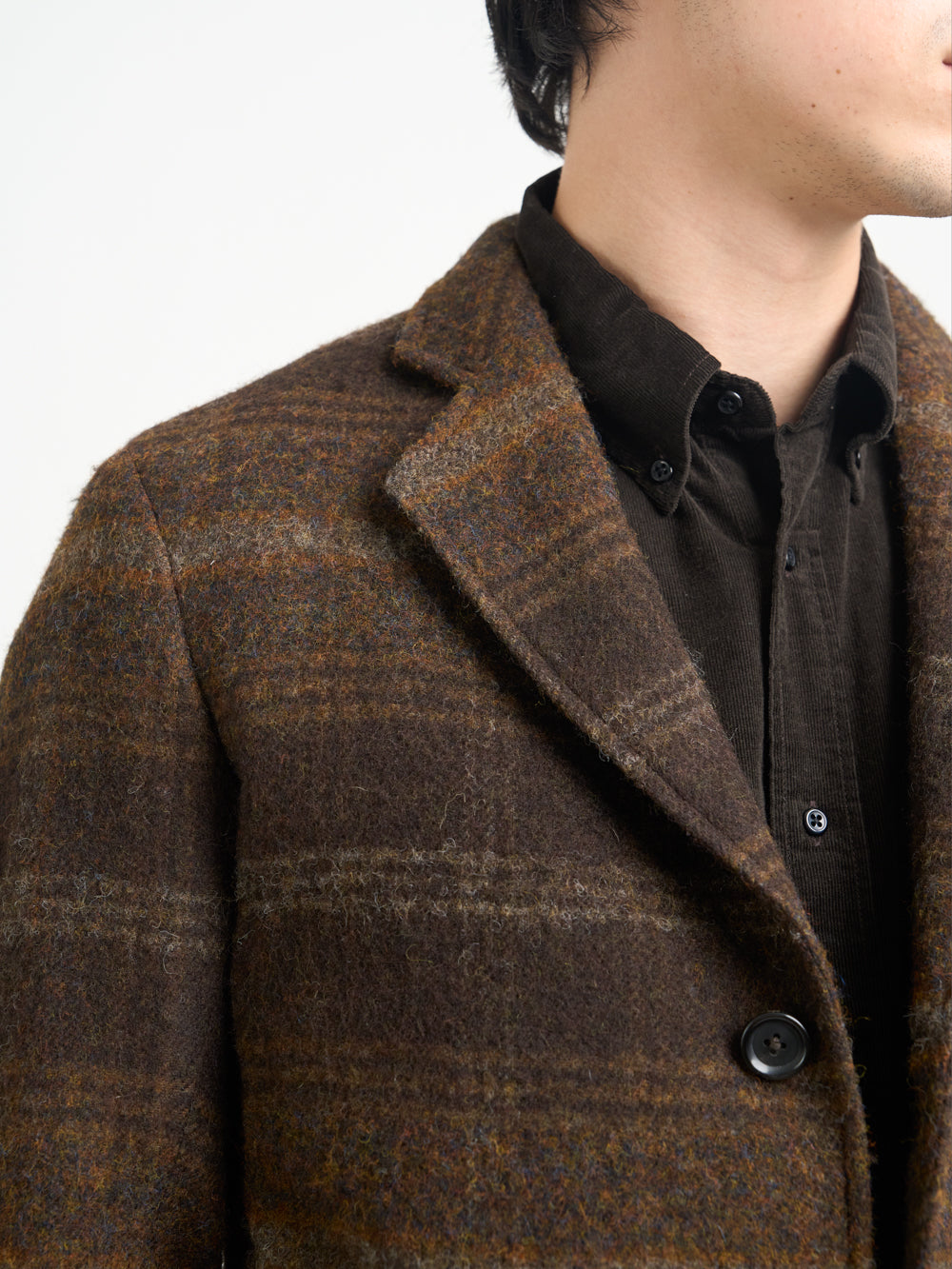 Up close collar shot of model wearing Oliver Spencer Men's Unstructured Notch Lapel Brown Plaid Jacket