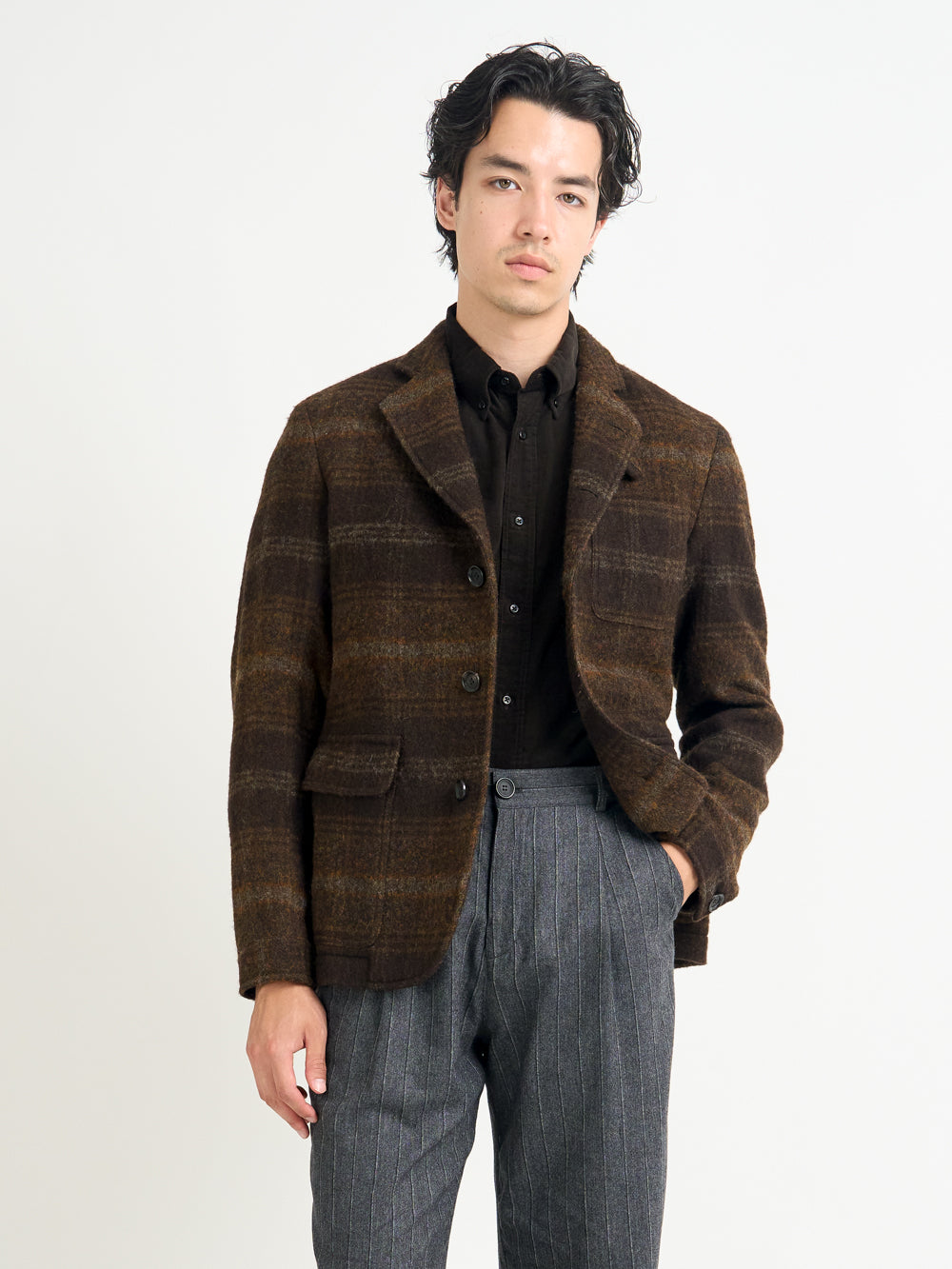 Closer shot of model wearing Oliver Spencer Men's Unstructured Notch Lapel Brown Plaid Jacket