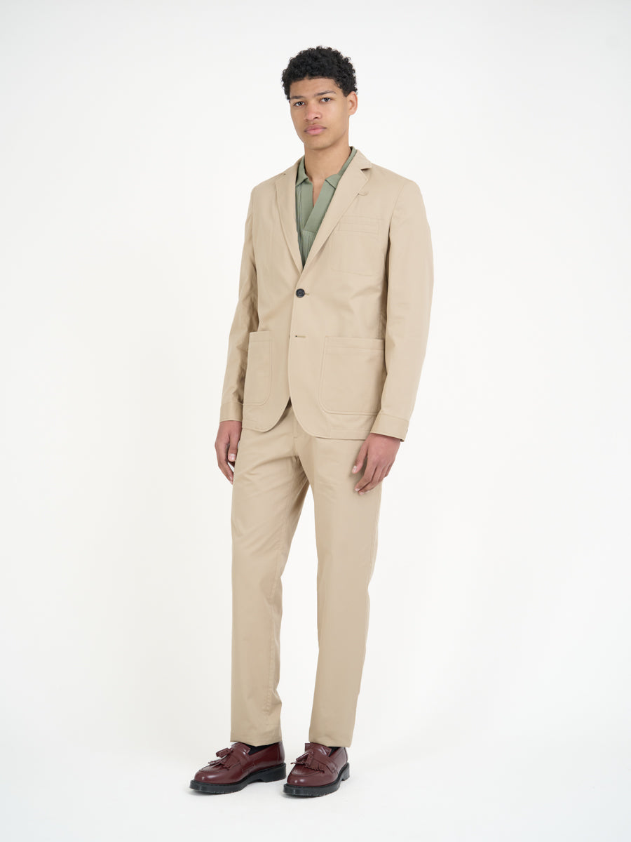 Model wearing Oliver Spencer Men's Unstructured Notch Lapel Beige Cotton Jacket